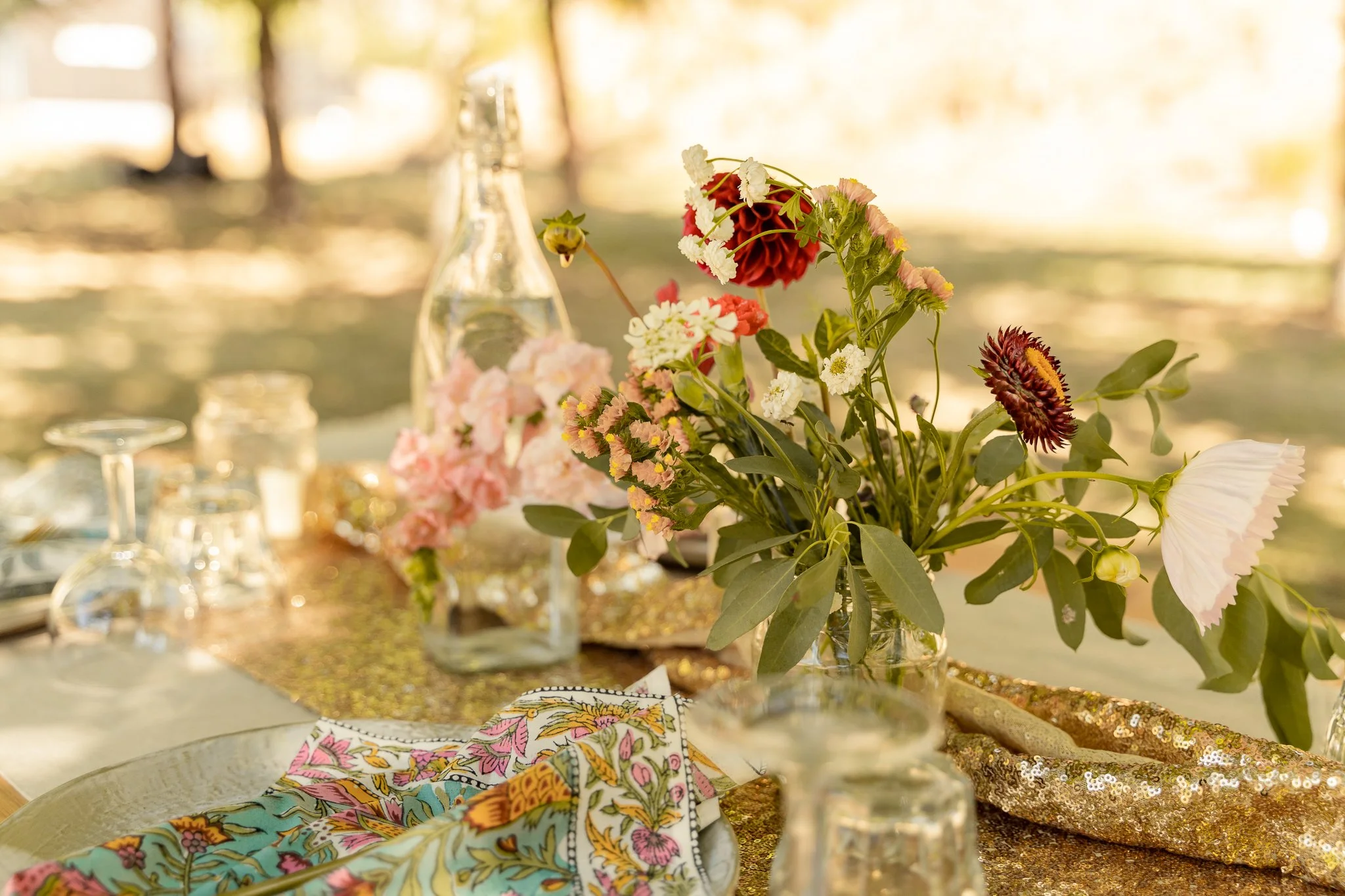 A close up of a wedding table with flowers in a vase.
