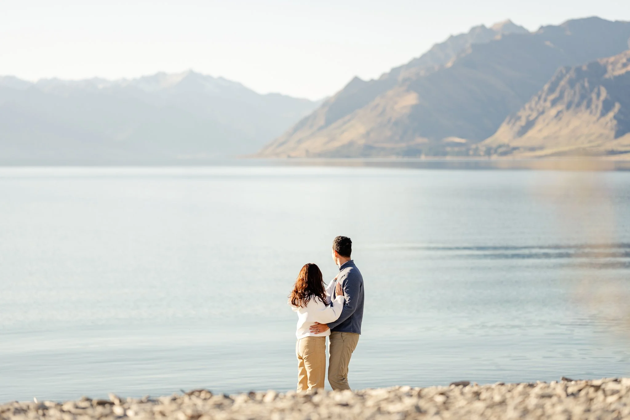 Couple standing on the shores of Lake Hawea