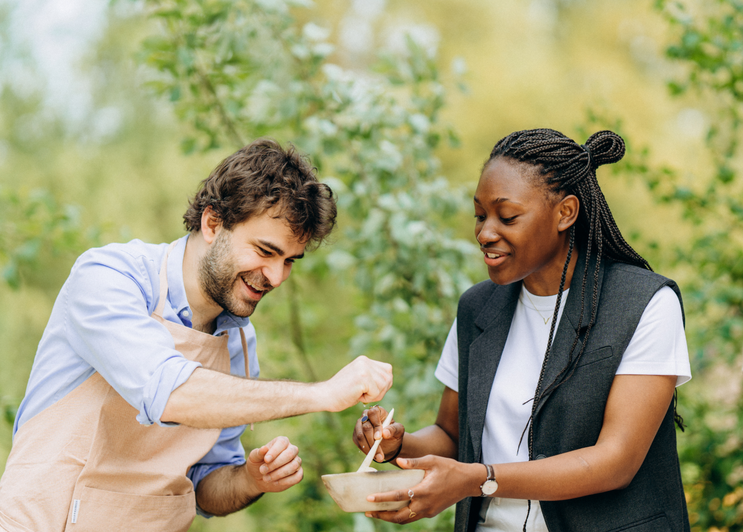 Two people cooking together during a kapi workshop in the garden