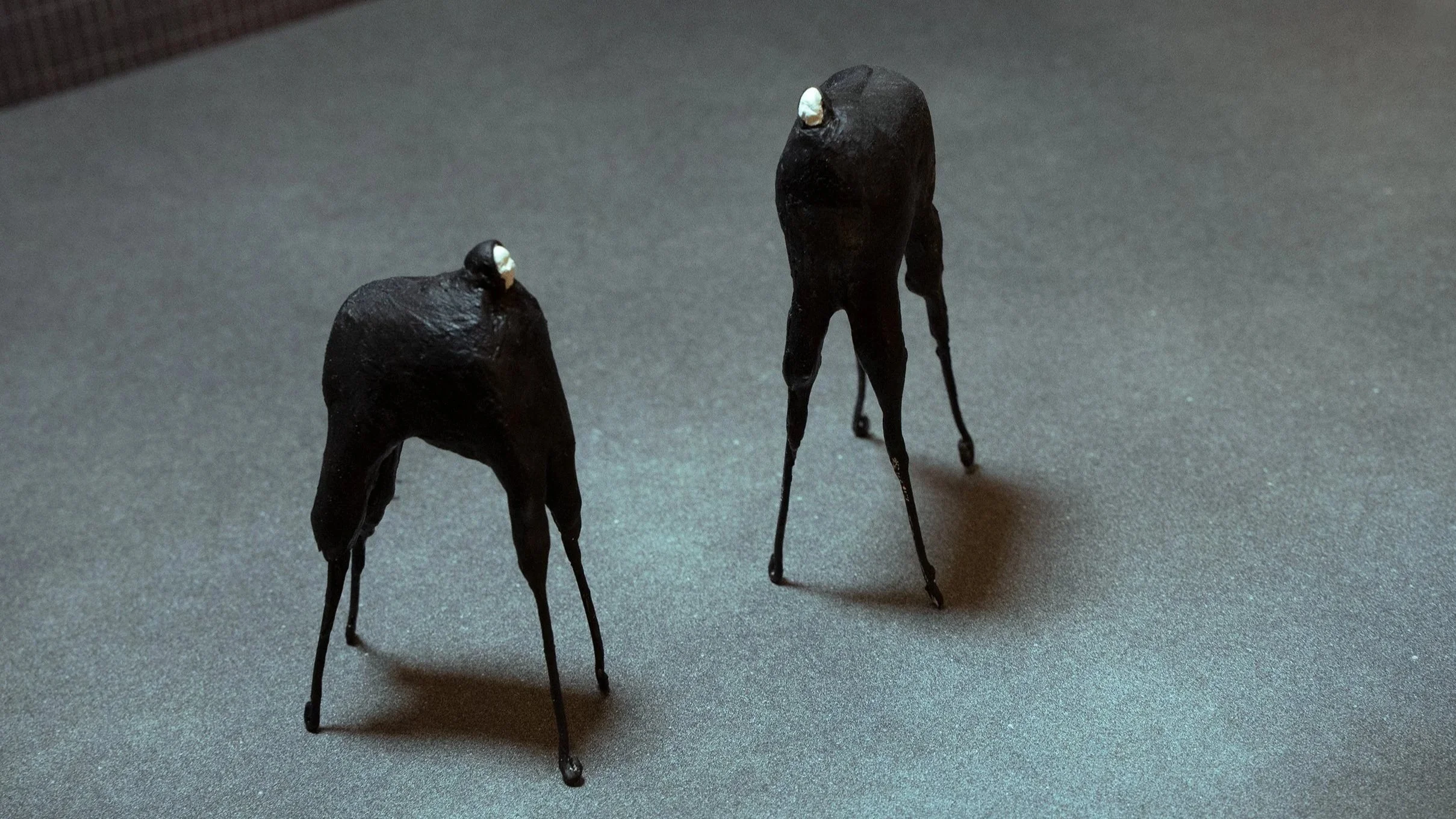 two horse-like suits, with actors inside