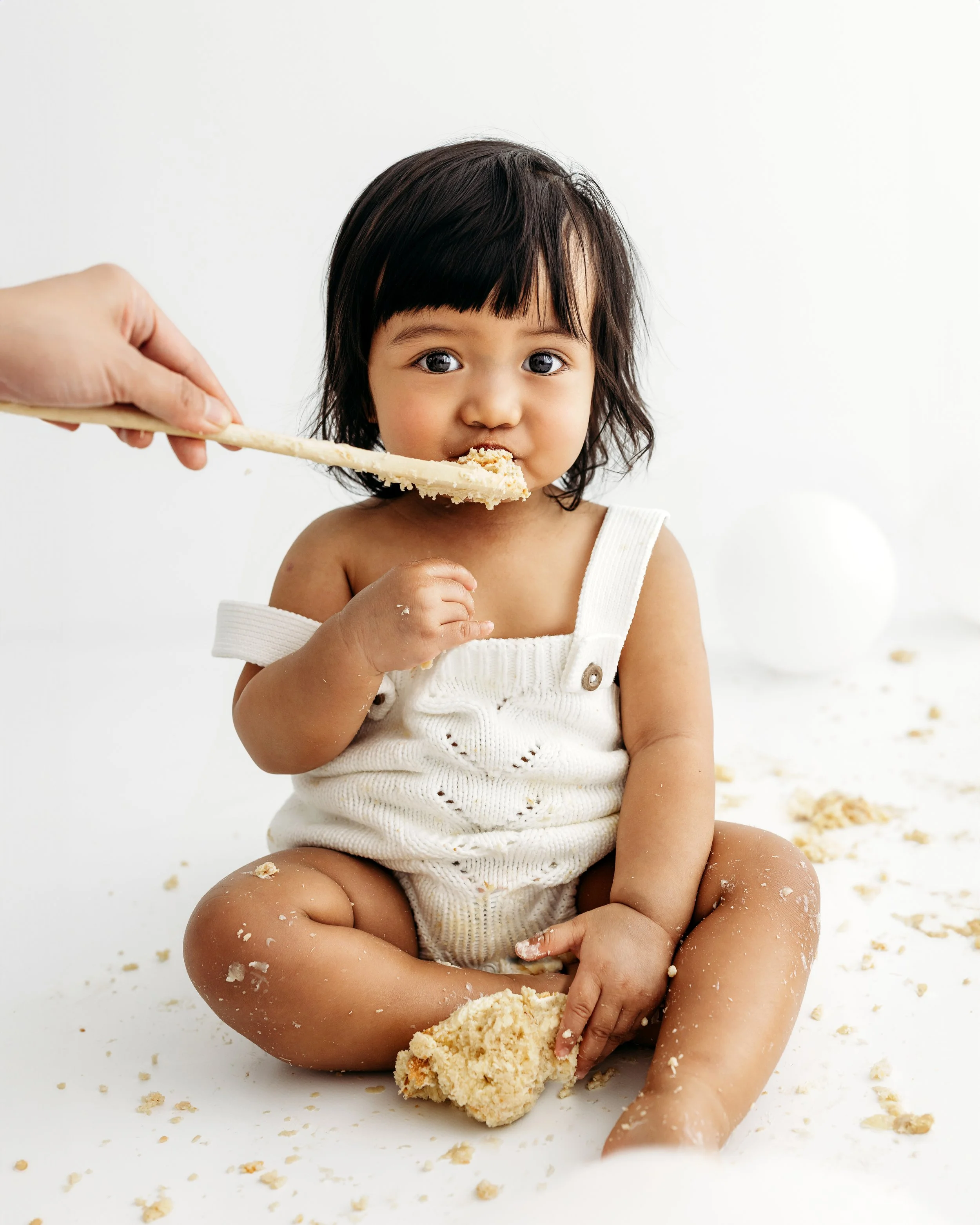Baby celebrating their first birthday with a cake smash photography session in Perth