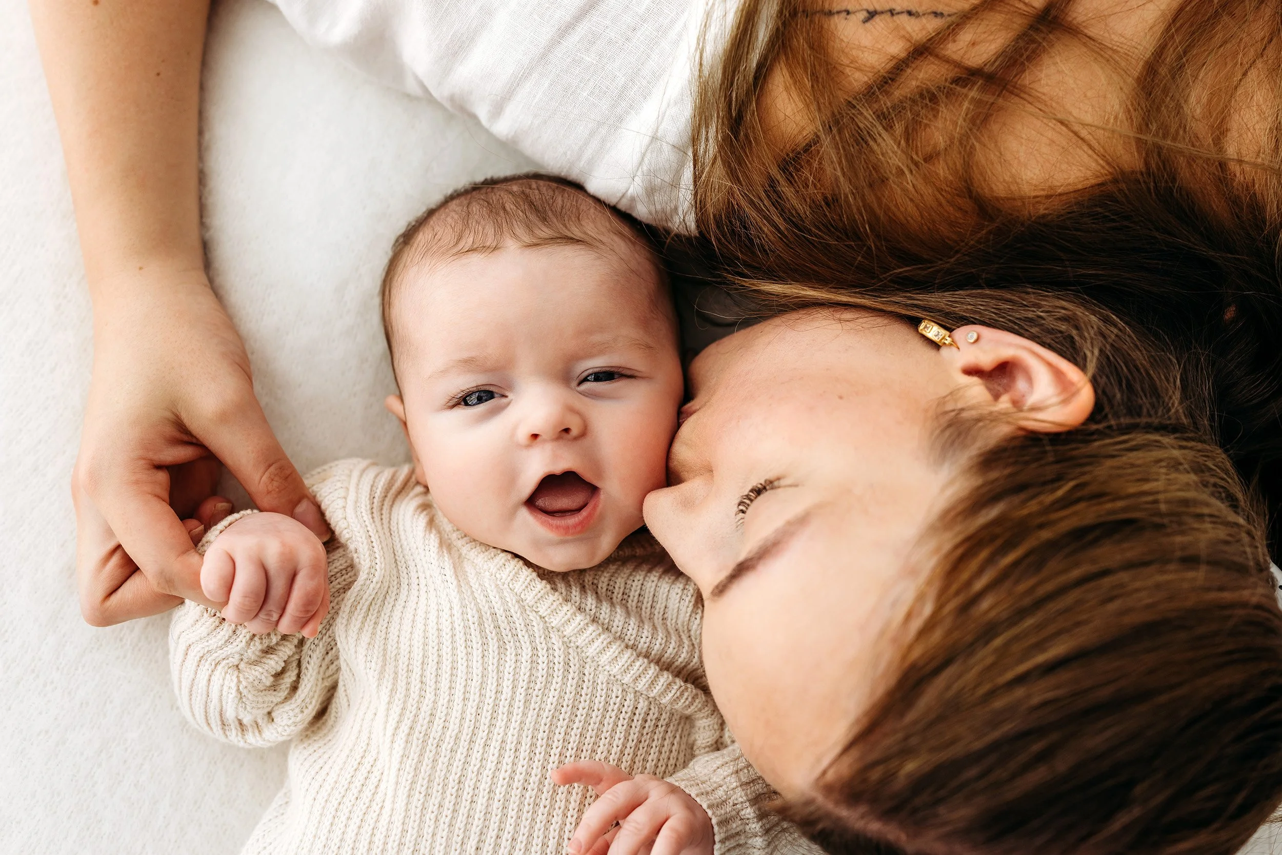 Mum cuddling beside her smiling baby during a baby photography session in Perth’s Swan Valley.