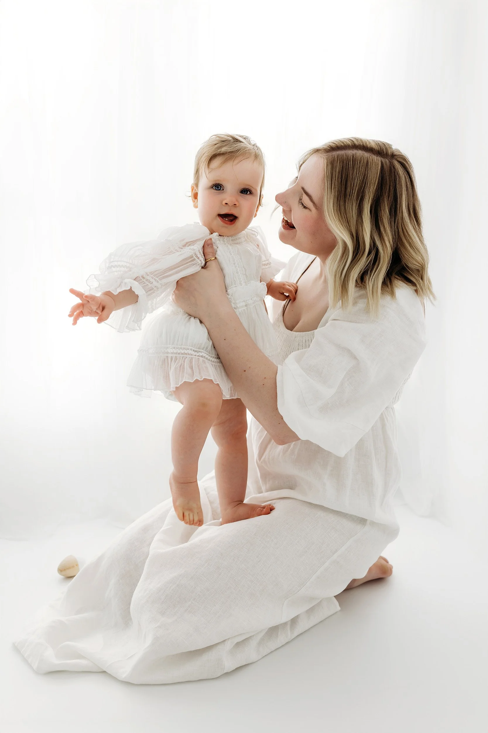 Mum smiling at her baby during a Motherhood Mini Session in Aveley
