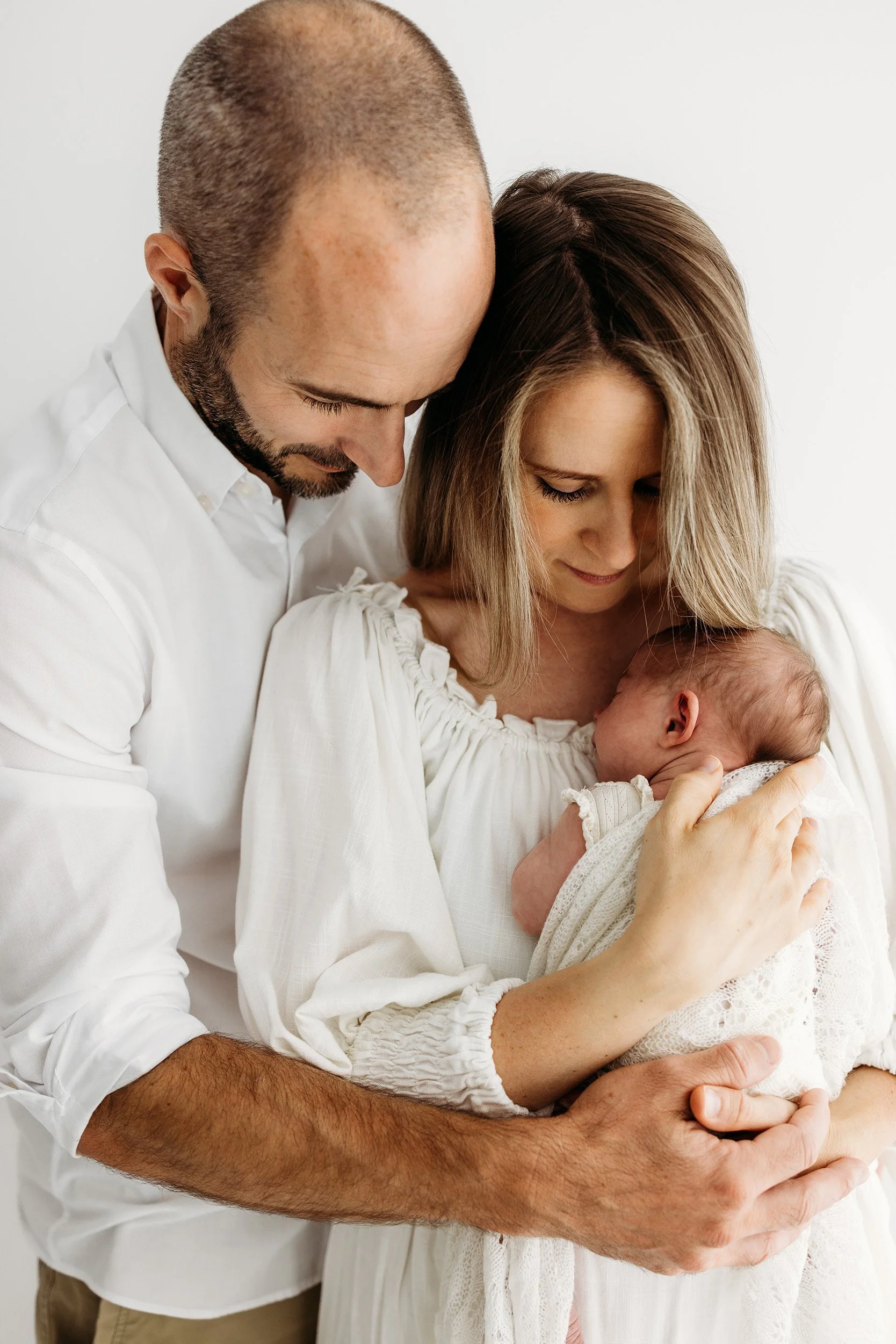 Mum holding her newborn baby during a relaxed newborn photography session in Perth.