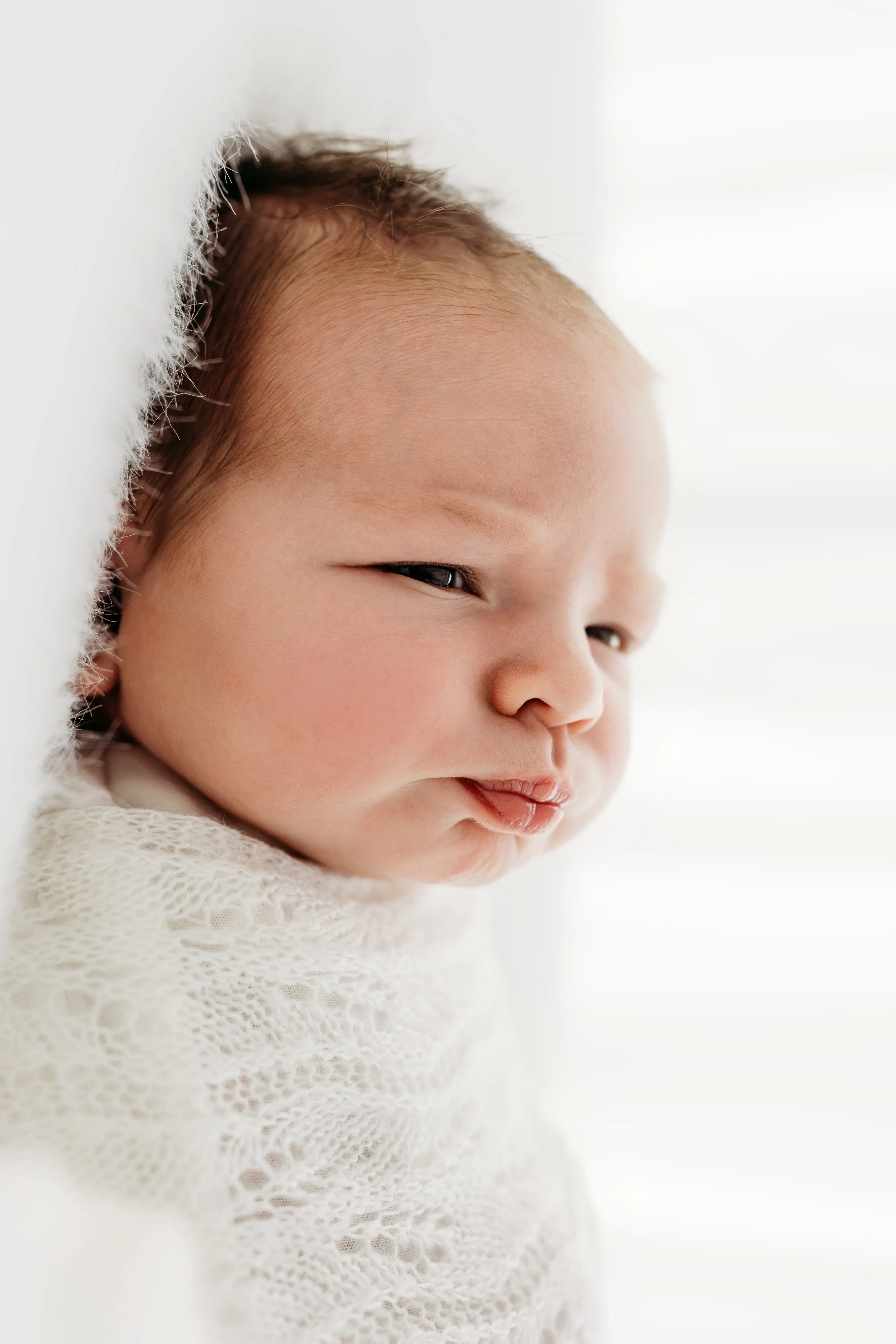 Newborn baby photographed during a relaxed studio newborn session in Aveley