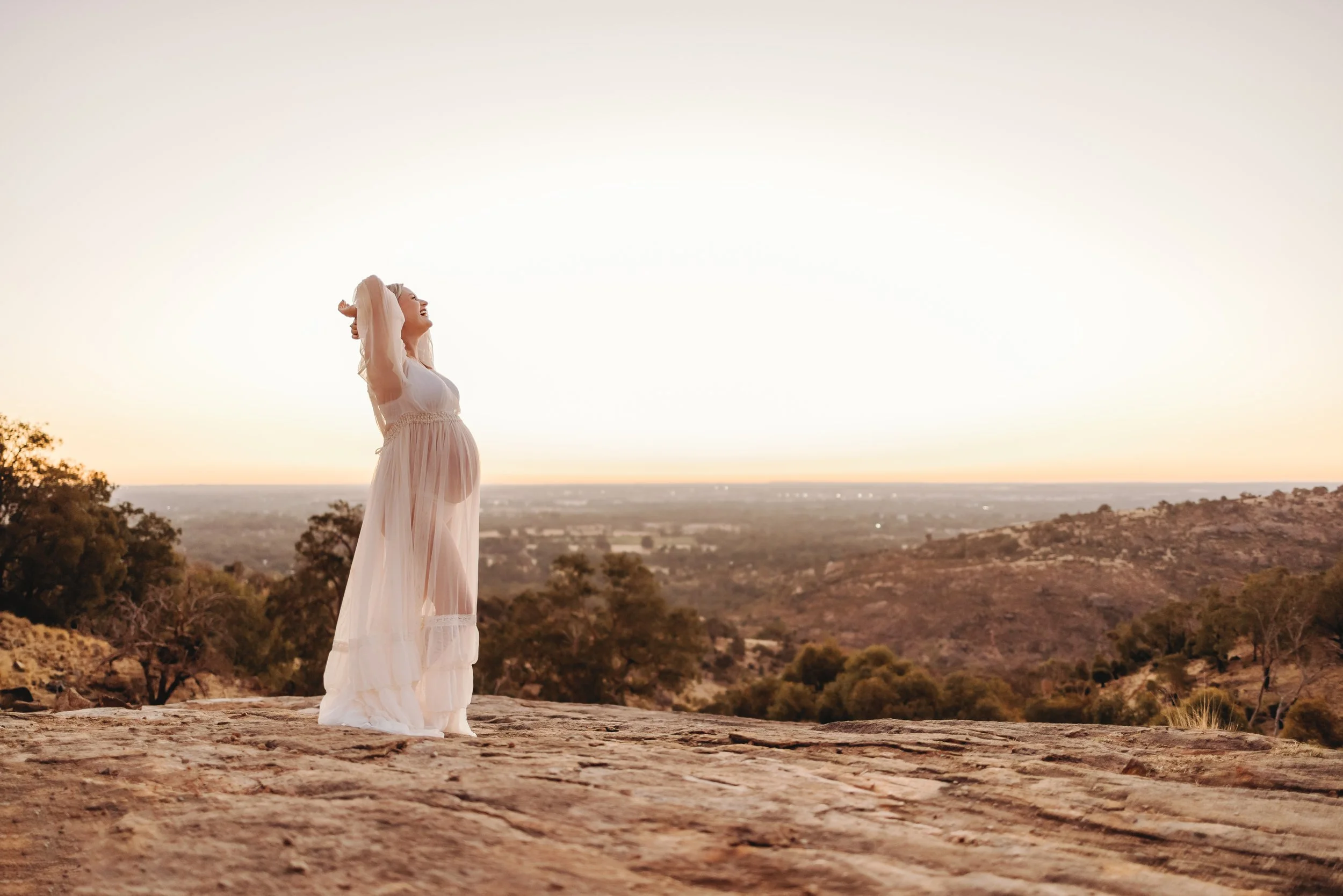 Expectant mum photographed outdoors in warm golden light during a Perth sunset maternity session.