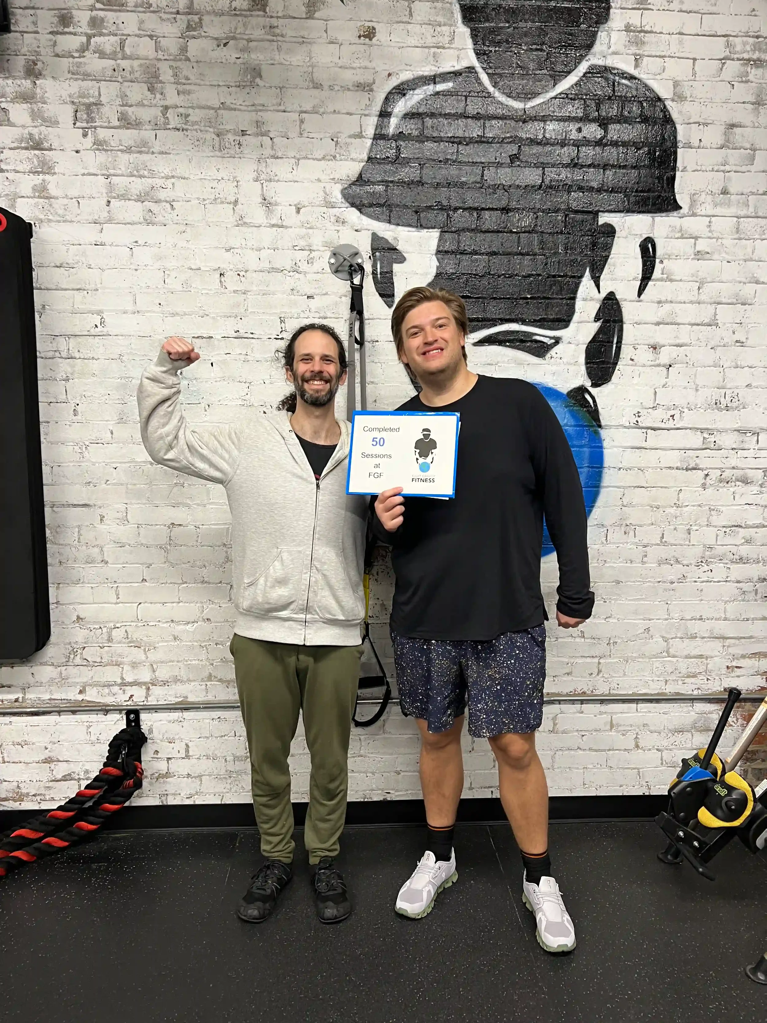 Fight Gravity Fitness trainer and client celebrating 50 sessions.webp