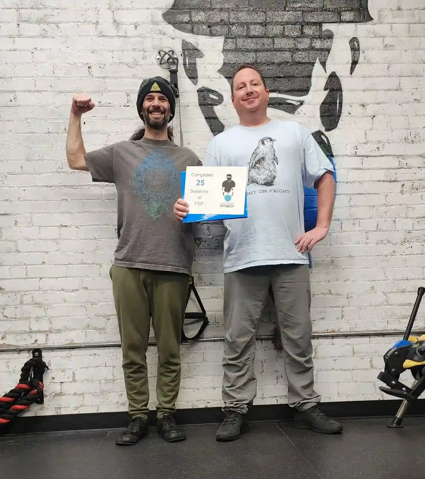 Fight Gravity Fitness Trainer with client celebrating 25 sessions