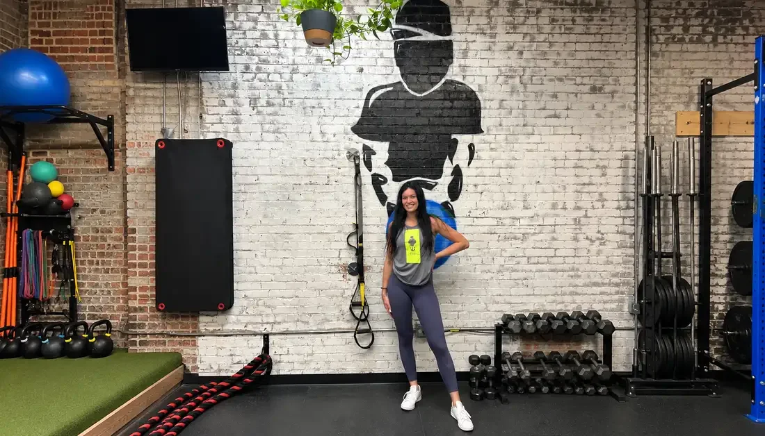 Private workout trainer with a client at a Denver personal training studio