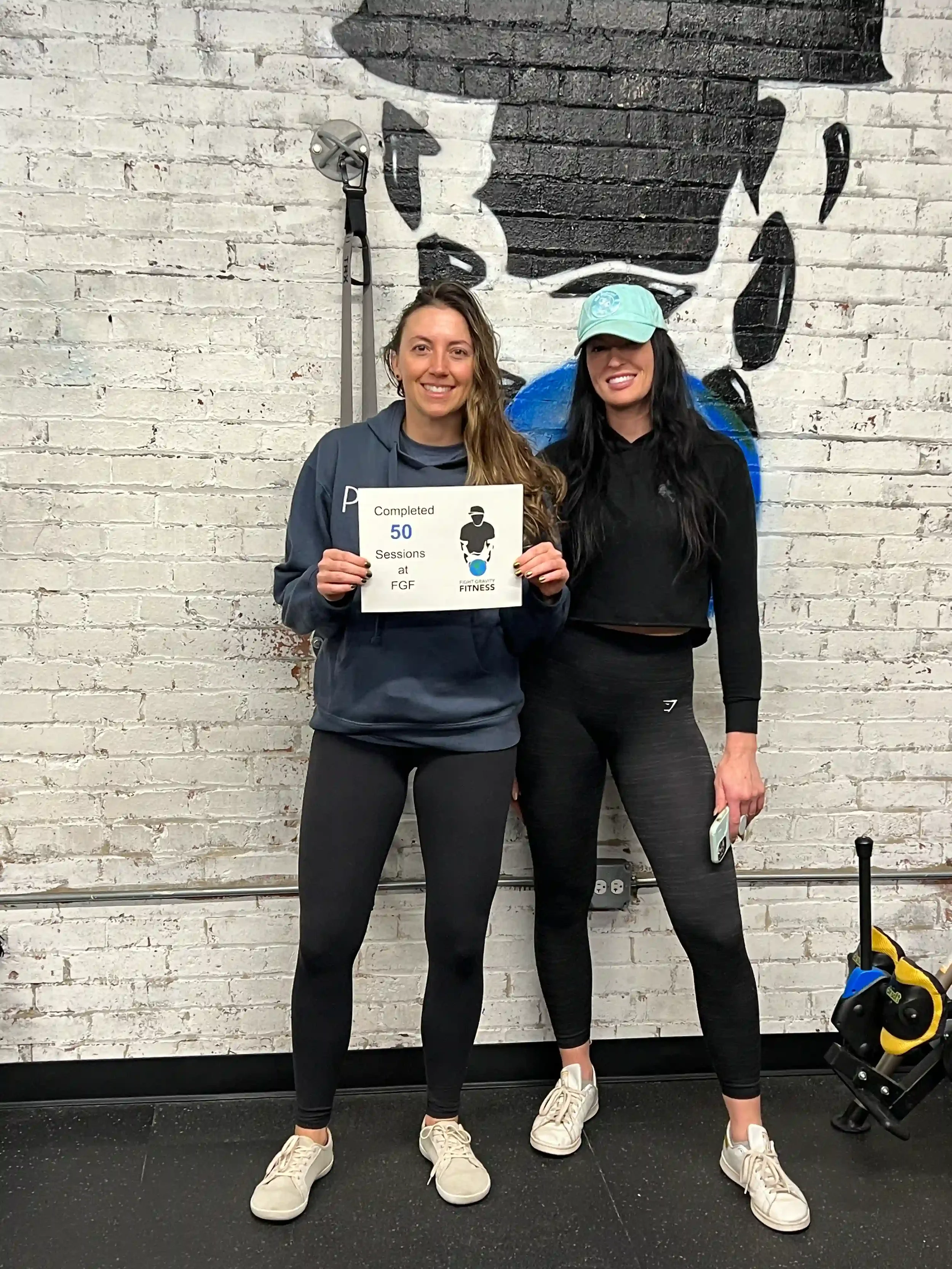 Fight Gravity Fitness Trainer celebrating 50 Sessions with Client