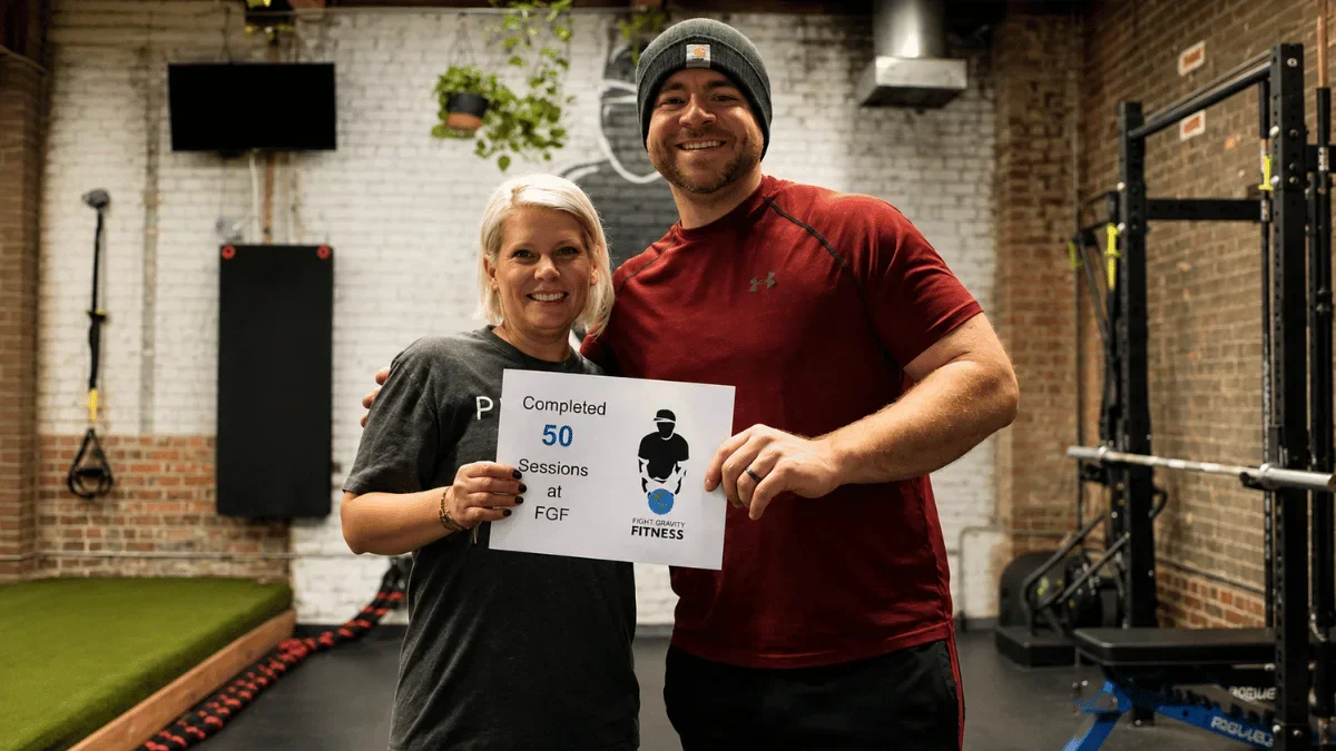 Fight Gravity Fitness clients celebrating completion of 50 personal training sessions in a private Denver fitness studio.