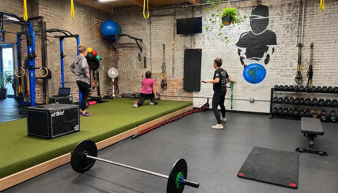 Private fitness instructor leading a strength workout in Denver