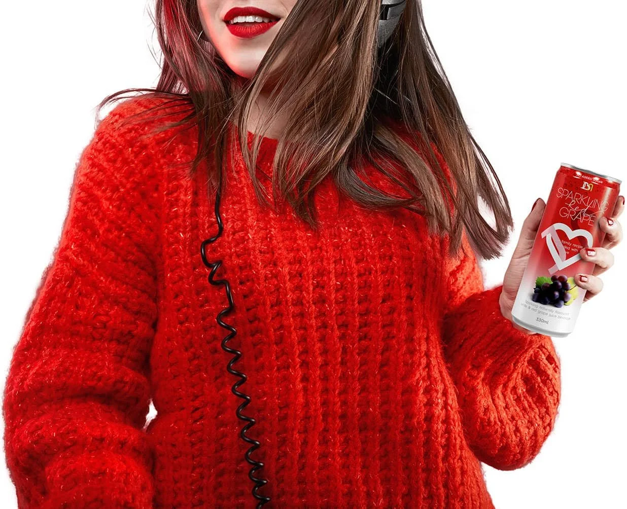 A female wearing a red sweatshirt and headphones on her head is holding a can of sparkling JBN red grape.