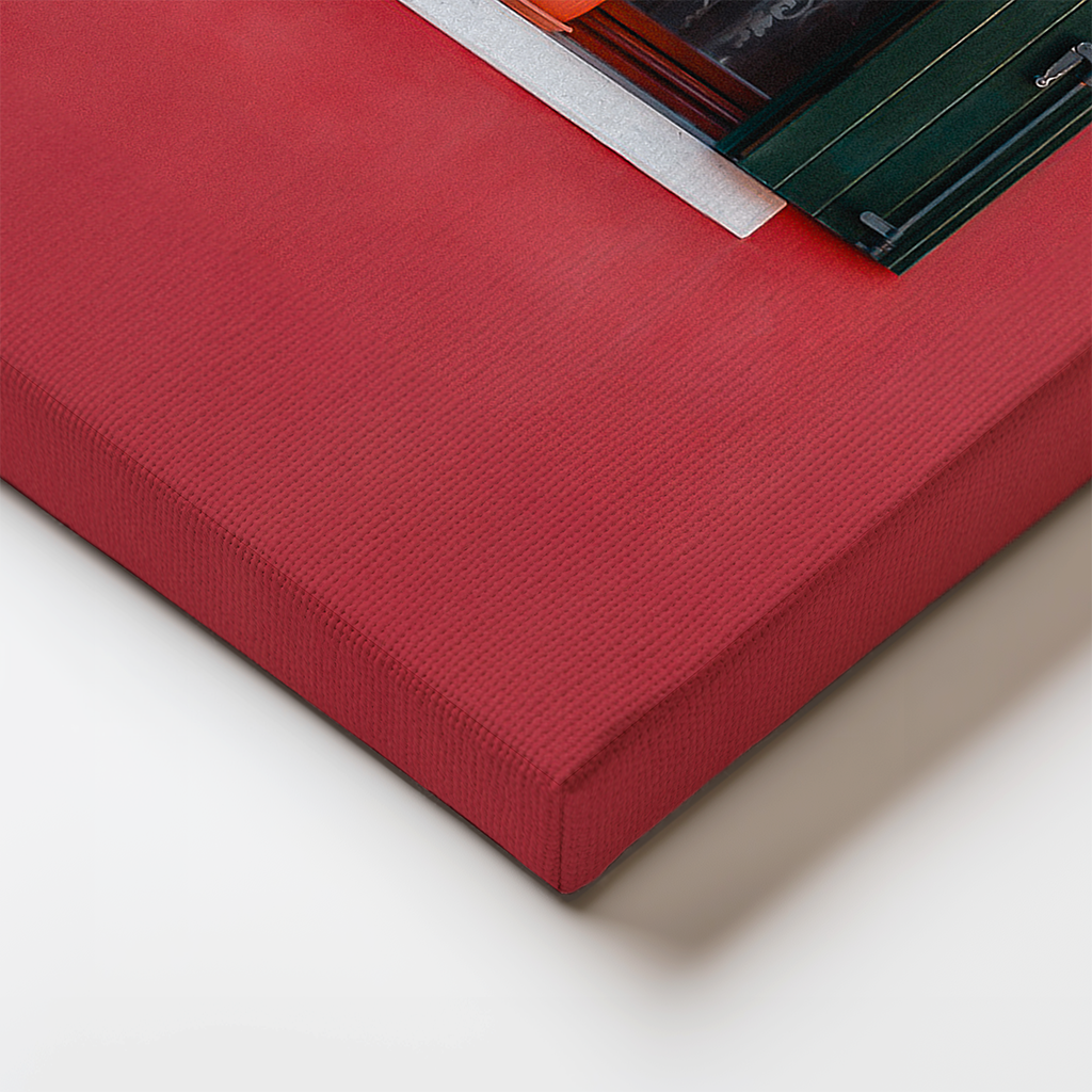 Edge detail of canvas wrap with bold red wall and dark green shutters.