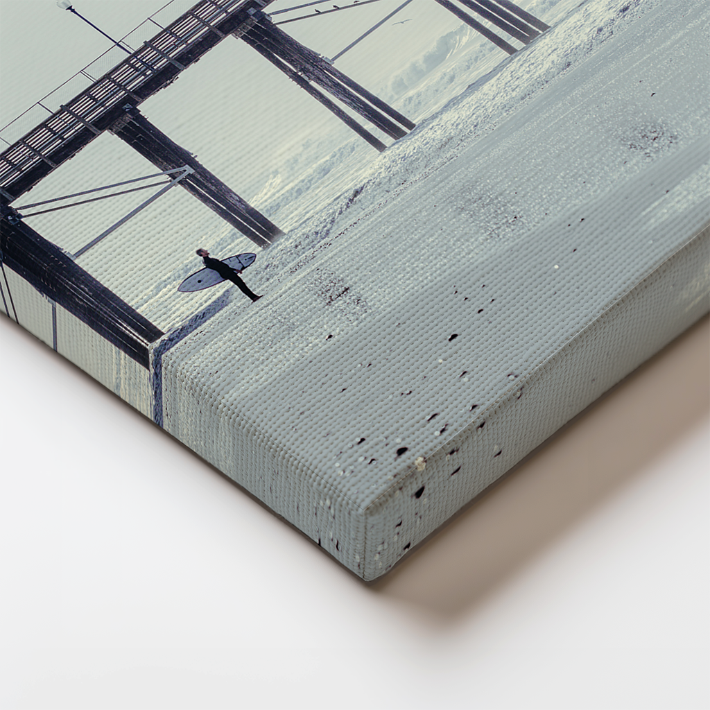 Close-up of the canvas edge wrap showing the soft pastel tones and wooden pier legs fading into beach reflections.