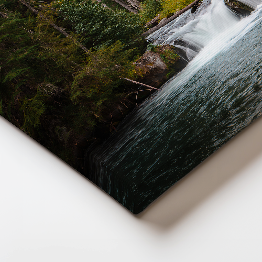 Close-up of stretched canvas edge displaying Oregon forest waterfall print. High-resolution detail of the North Umpqua River scene in gallery-style wall art