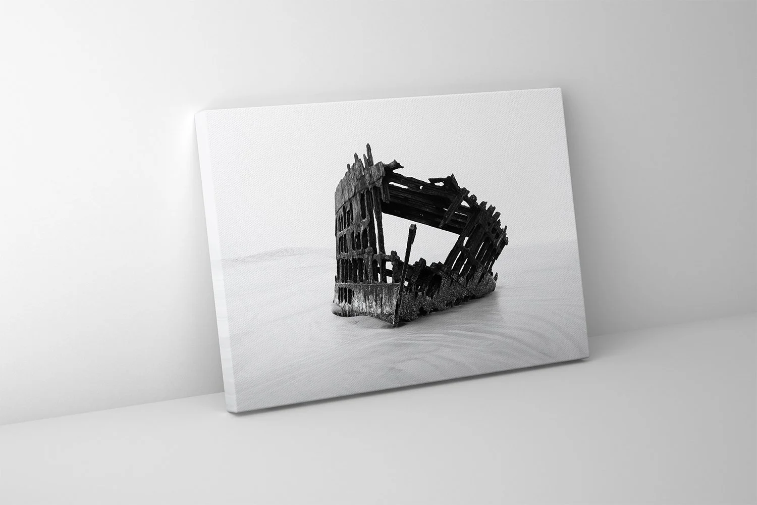 Canvas wall art featuring a stark shipwreck on the Oregon coast captured in a quiet black and white scene.