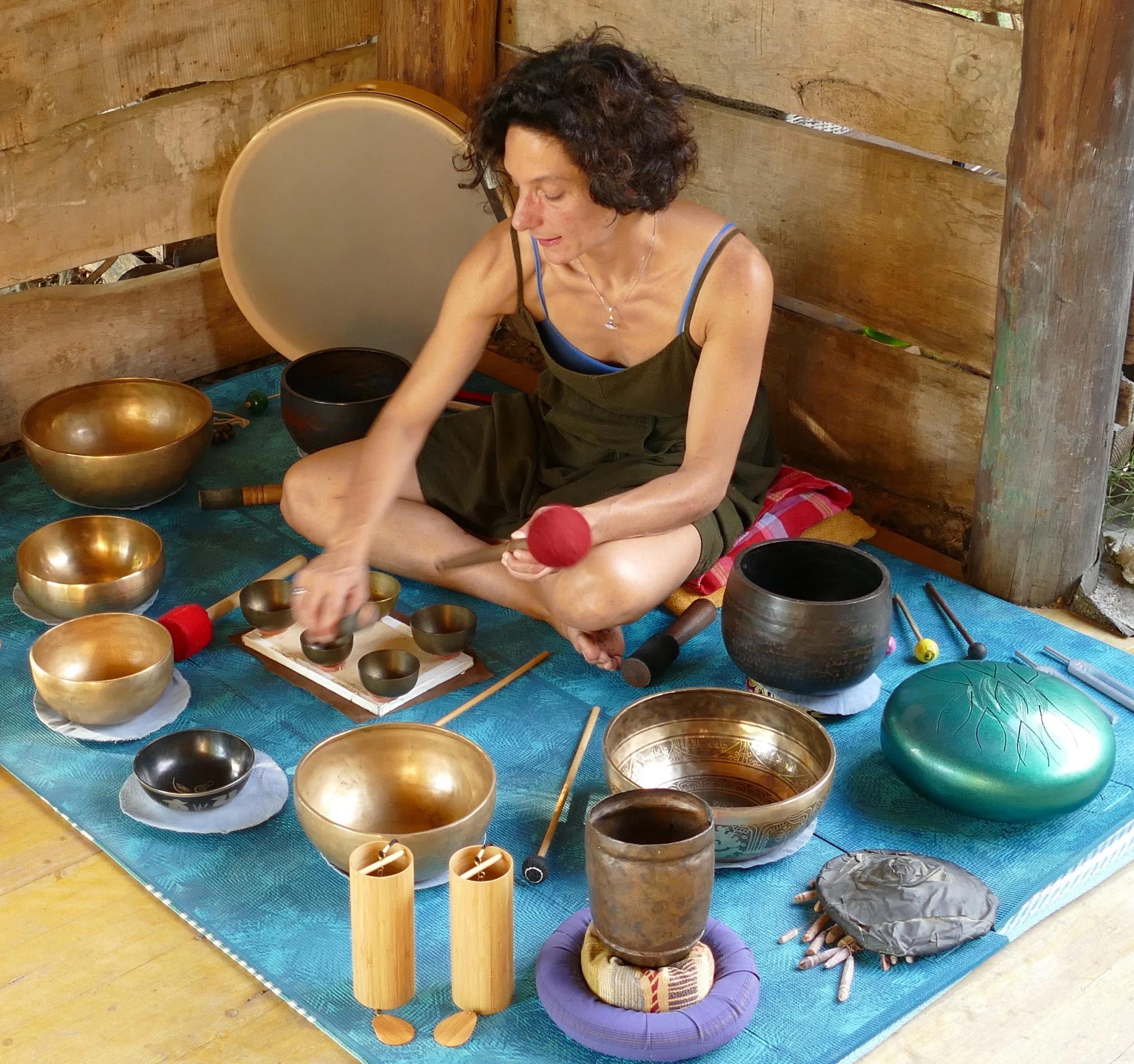A woman with long dark hair in a pink dress looking at a large crescent moon in the night sky amid a lush, dark forest with lens flare effects.