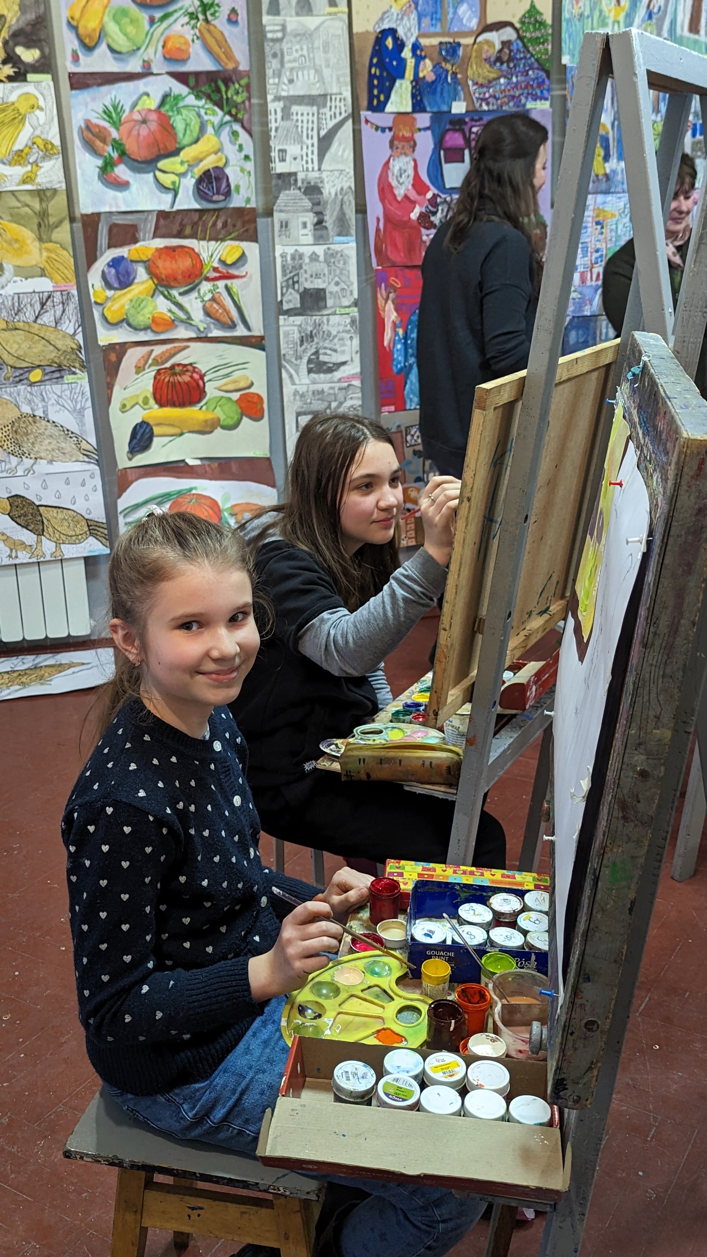 Younger students painting still life