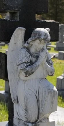 an angelic statue praying