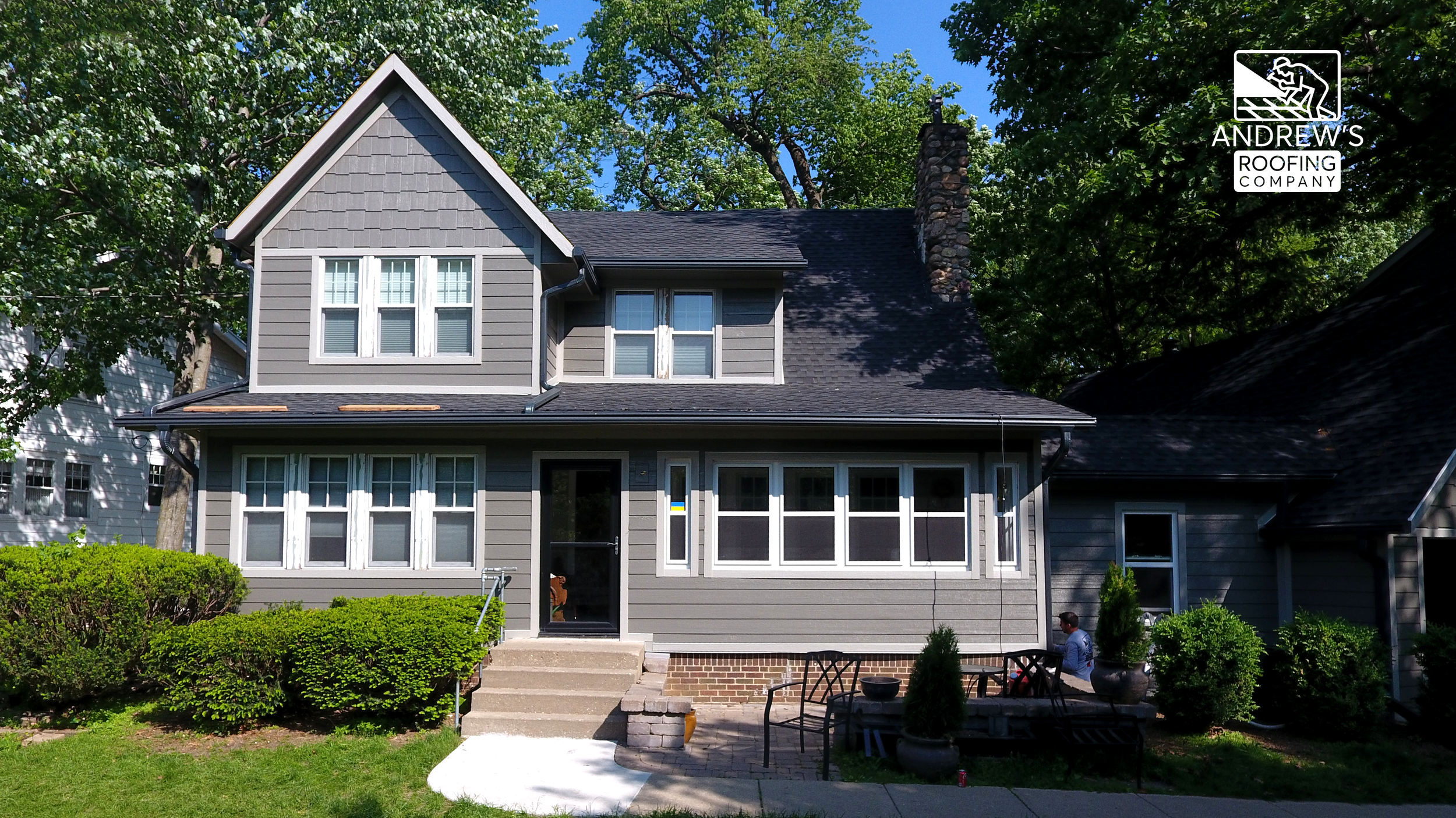 Front view of formerly white home now with new gray siding in Des Moines metro area.