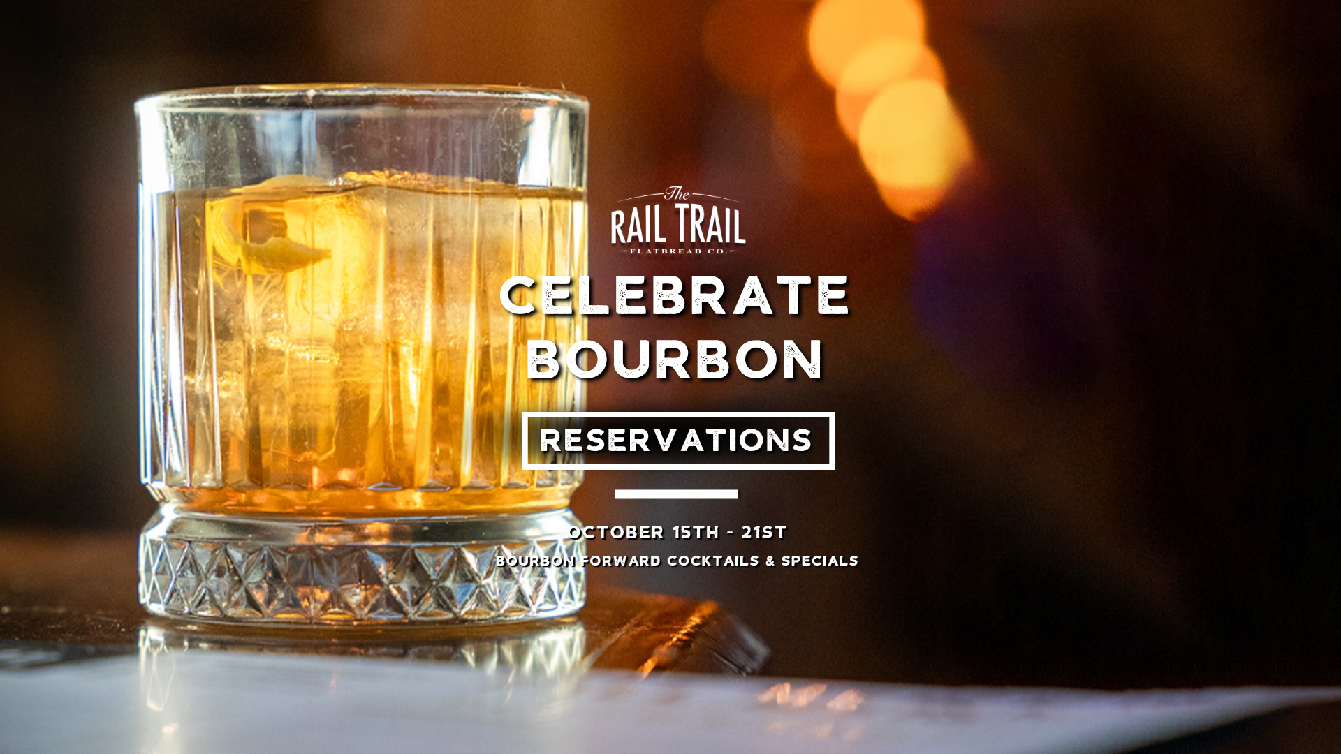 Glass of bourbon whiskey with ice cube on a reflective surface, with blurred warm-toned lights in the background, advertising a bourbon celebration event with dates October 15th to 21st and reservations information.