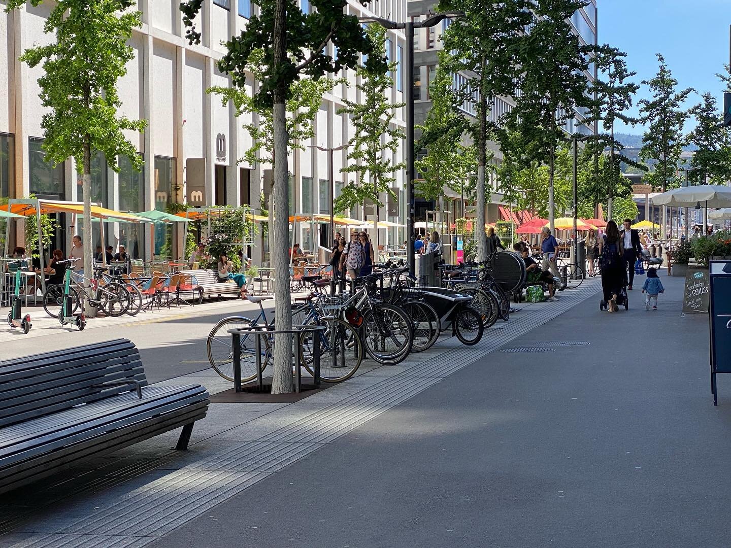 As seen on a Zurich street

A single zone for all street trees, furniture, and bike parking
At least 30 feet each side for outdoor dining 
About 15 feet for service and private vehicles
This is a new street in Europaallee district