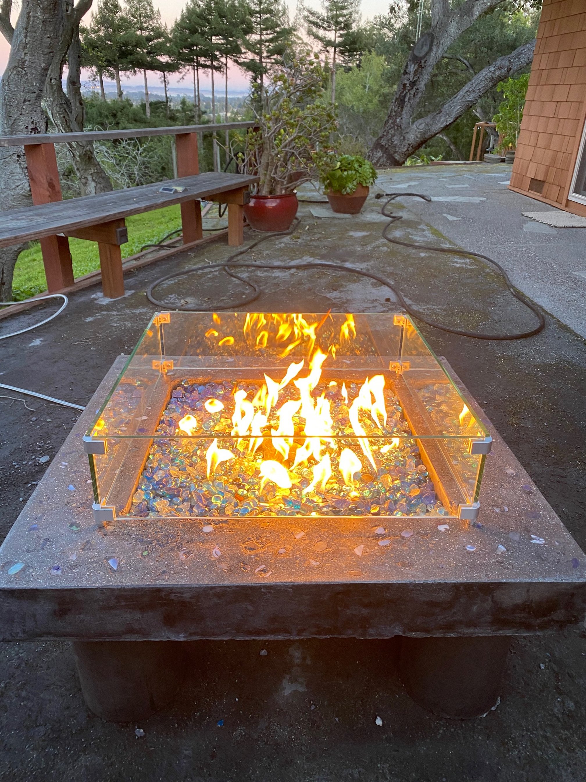 Sea glass and used concrete forms used to build firepit