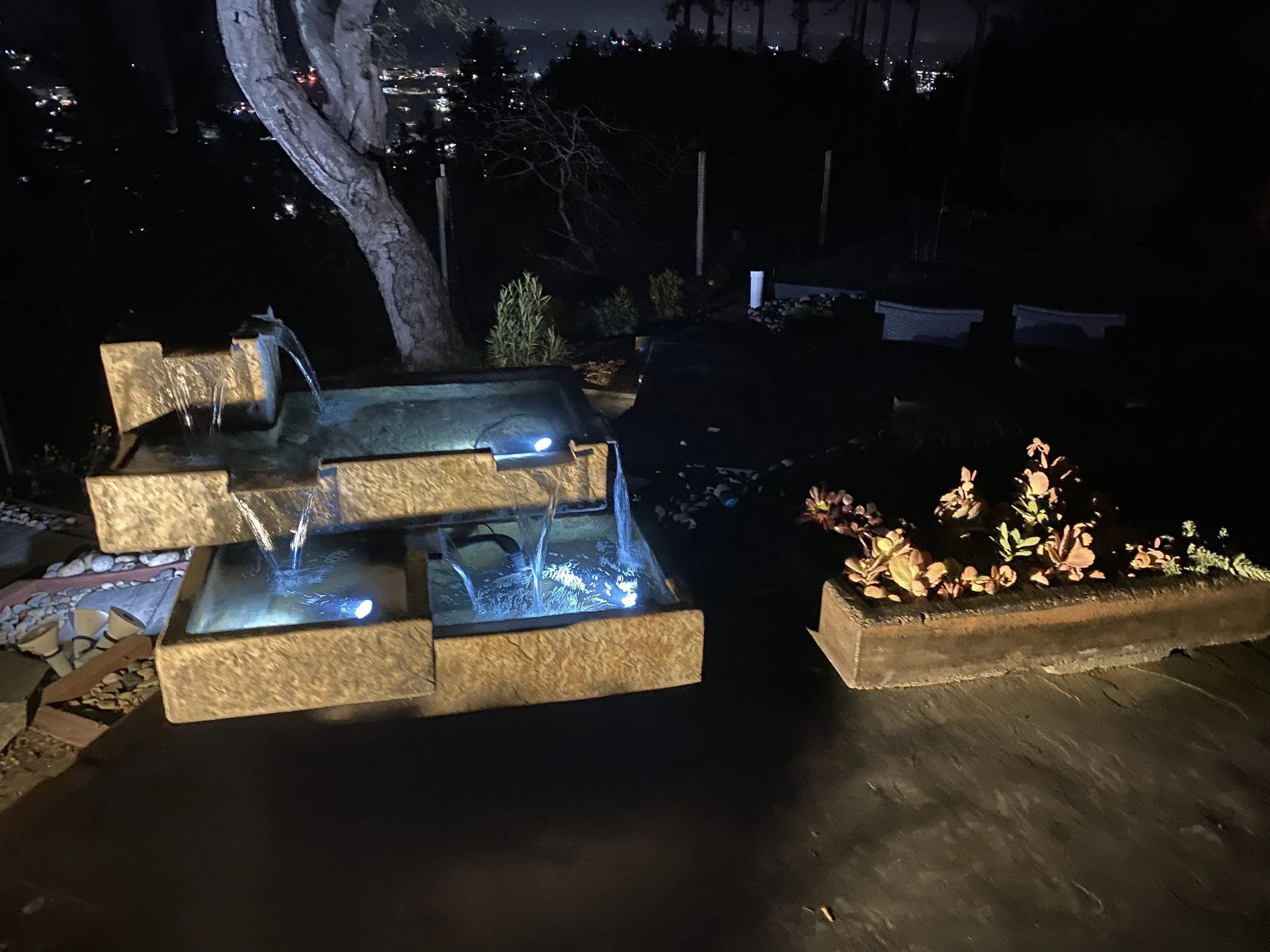 Outdoor Bauhaus fountain and matching planters for succulents to create physical and energy barrier