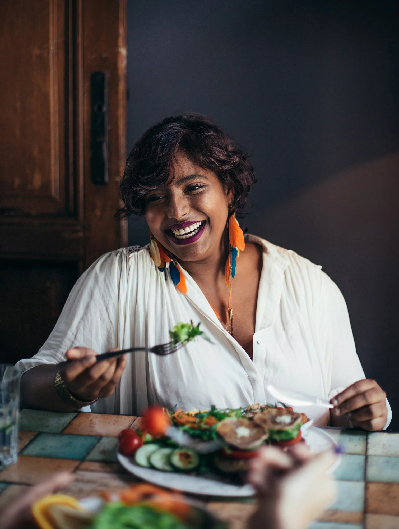 About Portrait of a beautiful Indian woman eating in a restaurant