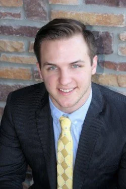 Smiling man wearing a tie and suit jacket