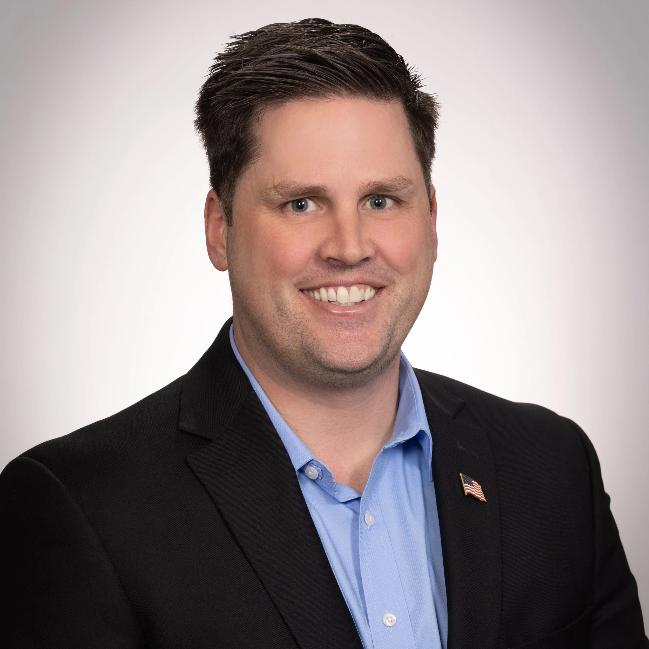 Young man with suit jacket and flag pin