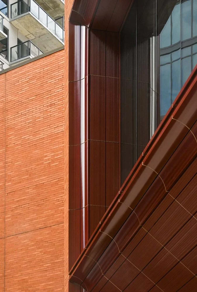Vertical corner detail of the Paycor HQ terracotta cladding system, highlighting custom curved TONALITY panels, crisp joint lines, and engineered sub-framing by exo Surfaces.