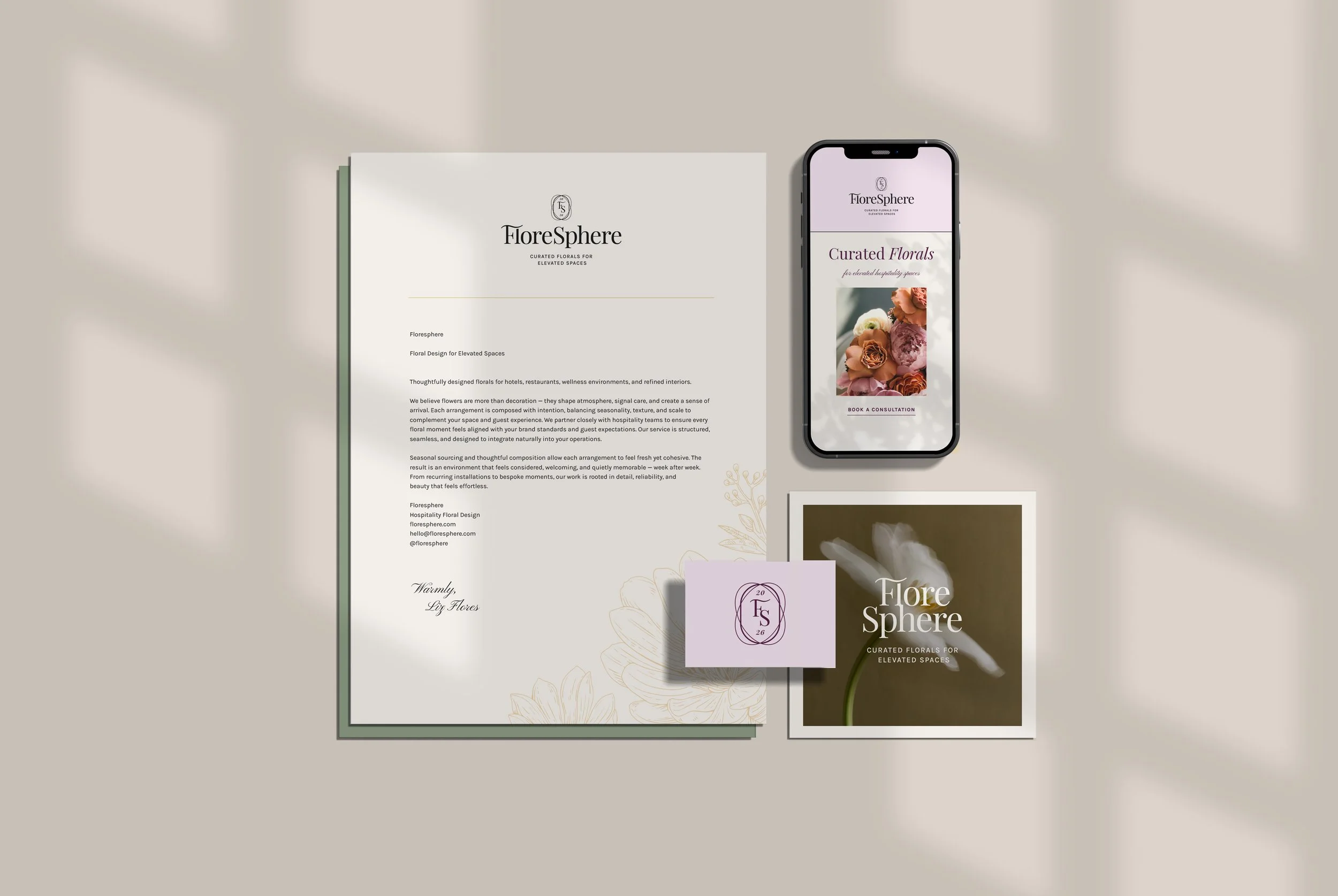 Collection of promotional materials for FloreSphere, including a brochure, a business card, a magazine cover, and a smartphone displaying the FloreSphere website, all featuring floral designs and branding.