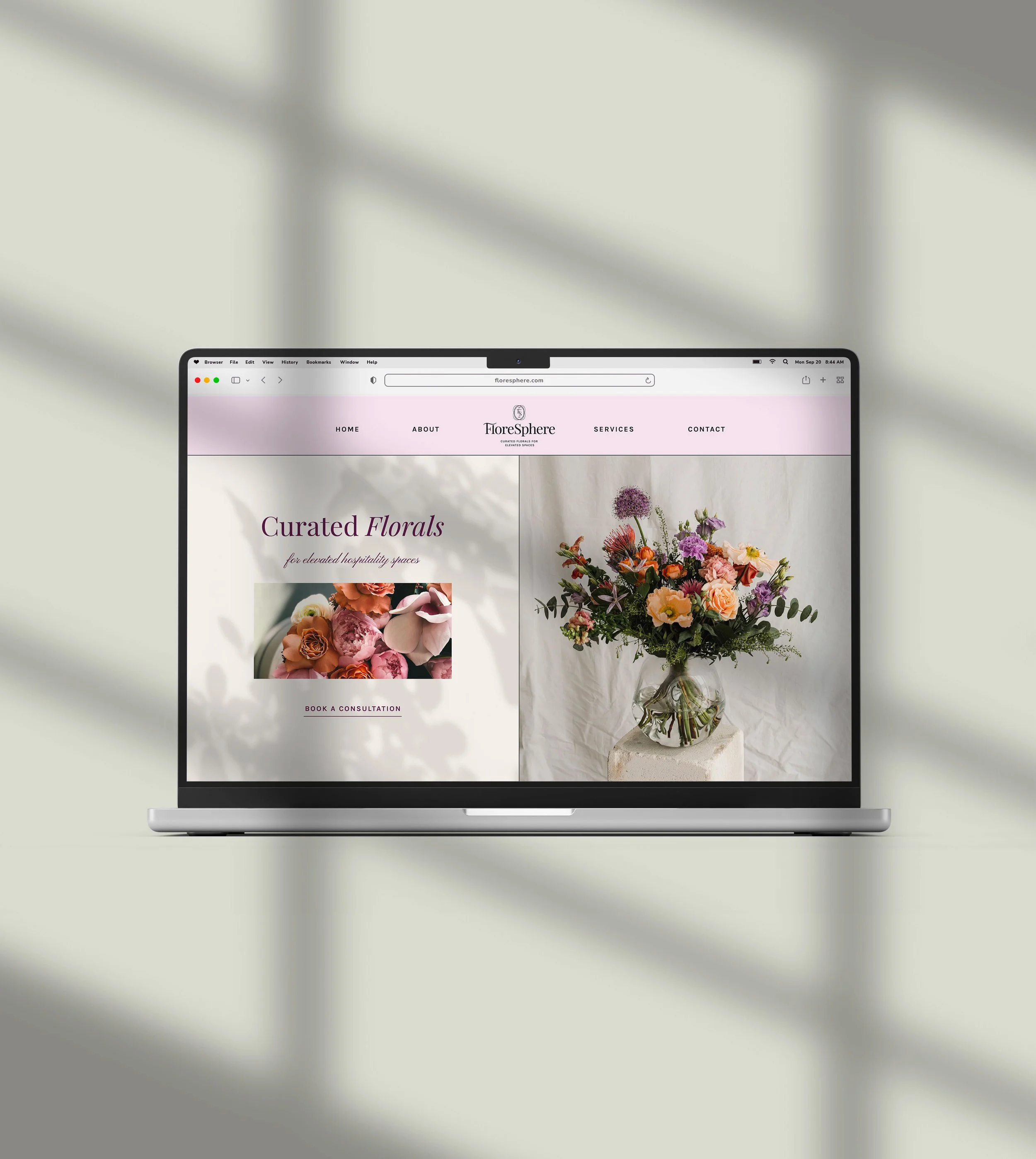 Laptop displaying the homepage of FloreSphere, a floral arrangement website, with a bouquet of flowers on the right and text on the left.