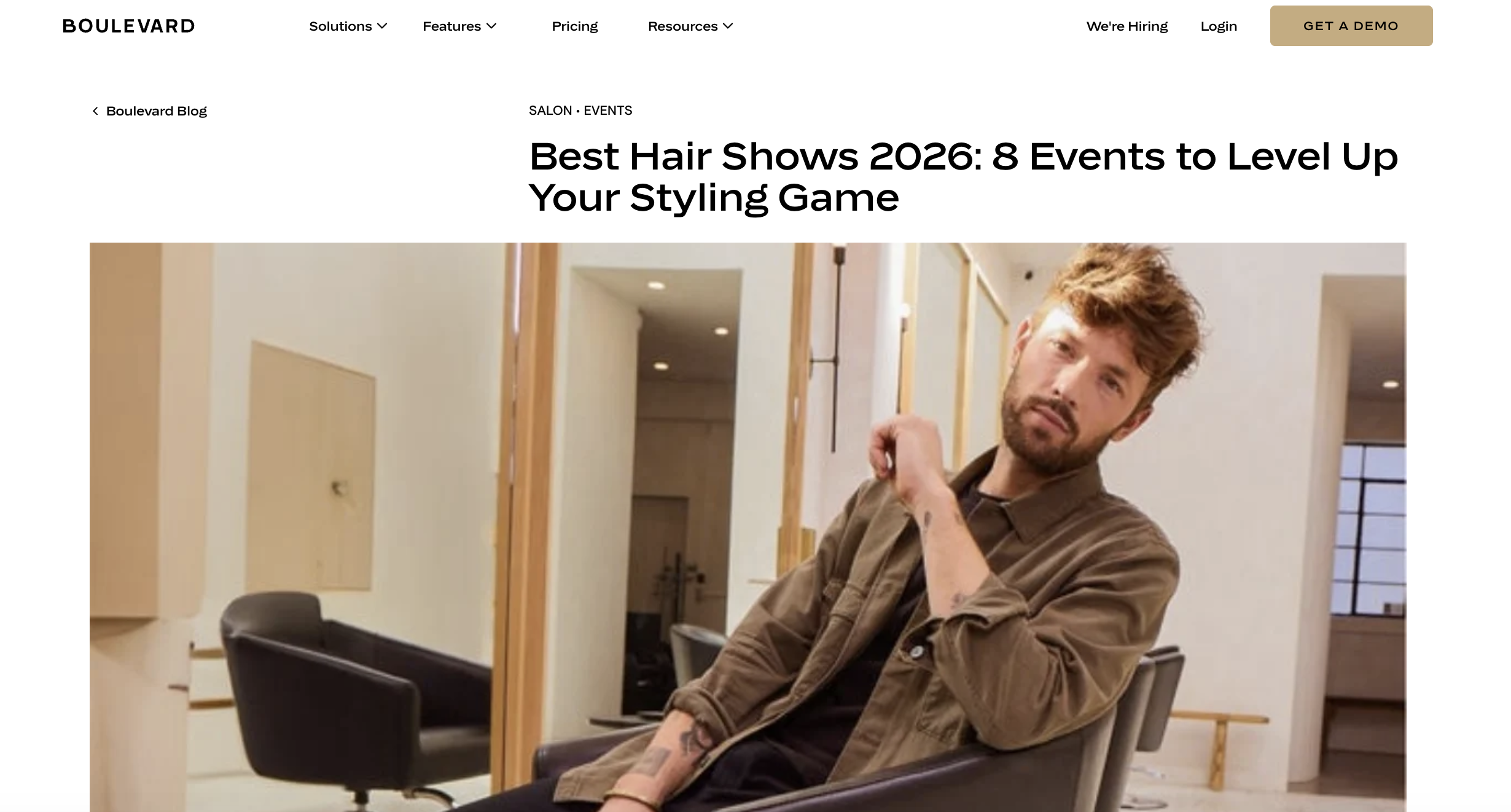 A man sits in a salon chair.