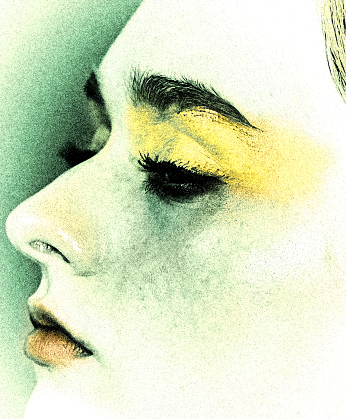 A close-up artistic image of a woman's face with her eyes closed, featuring bold yellow eyeshadow and nude lipstick, with a focus on her profile and makeup details.