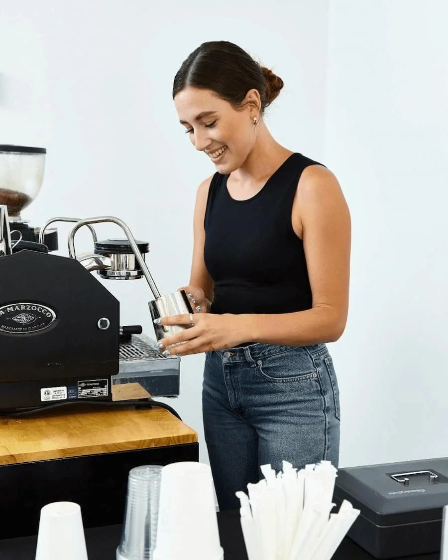 Barista frothing milk at a coffee cart in LA