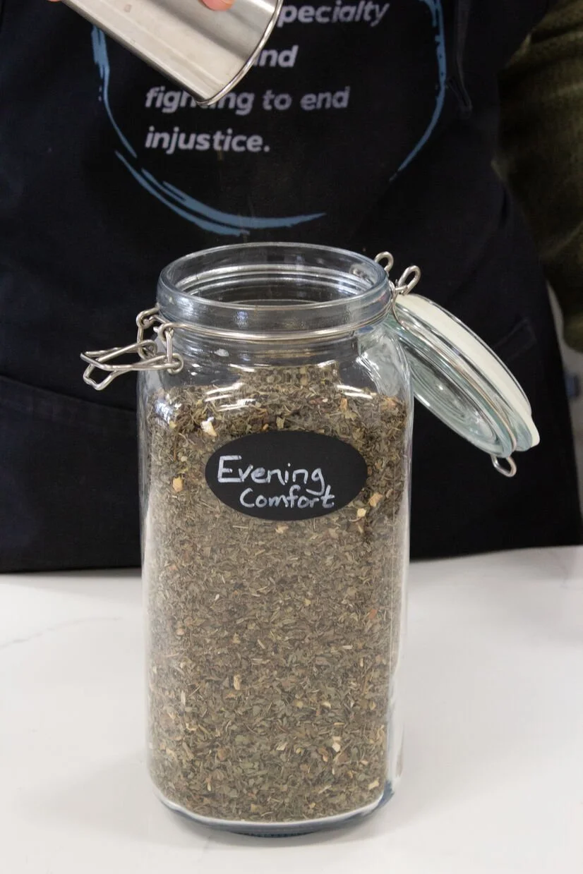 glass jar with black label with "evening comfort" written on it, which is a loose leaf tea at Inicio Coffee.