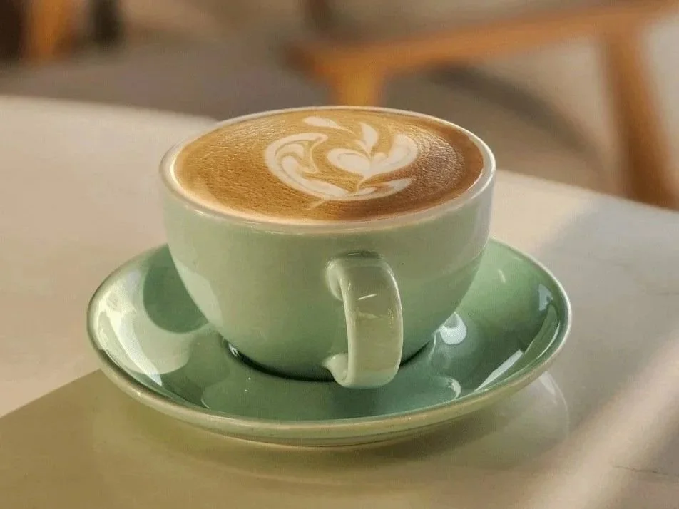 Picture of a latte in a mug, one of the best coffee orders to try for newbies