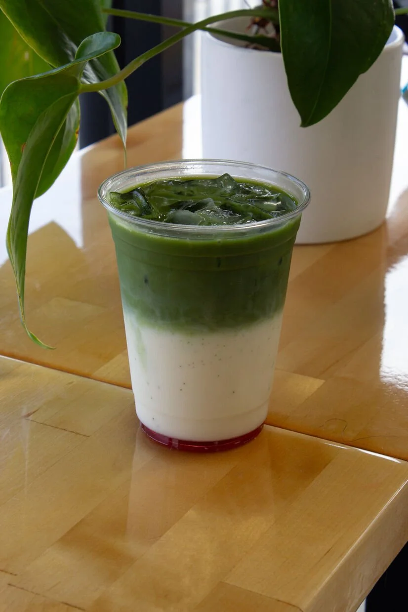 iced raspberry matcha with plant behind it