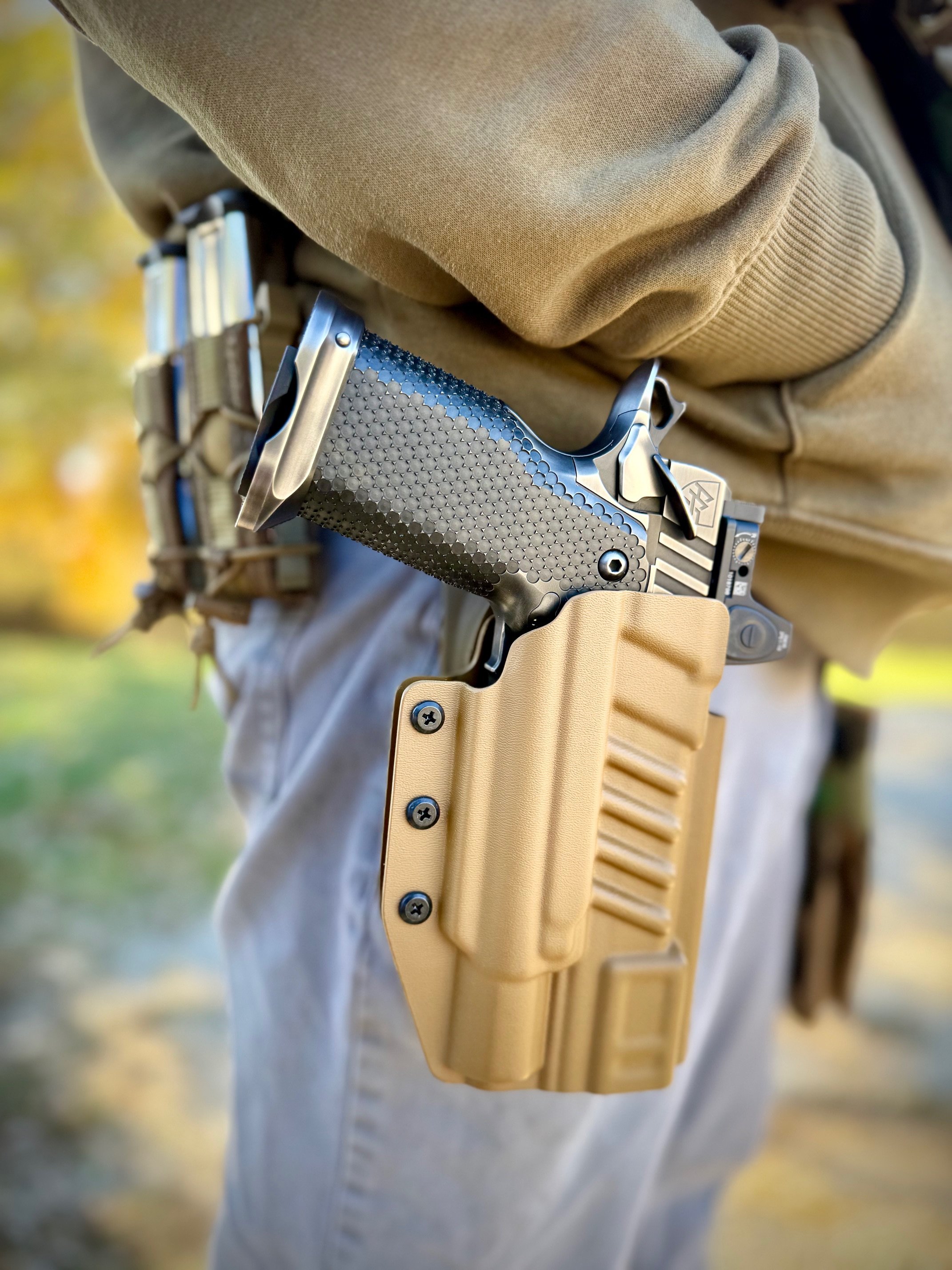A battleworn nitride finish by Alpha American Firearms shown in a holster