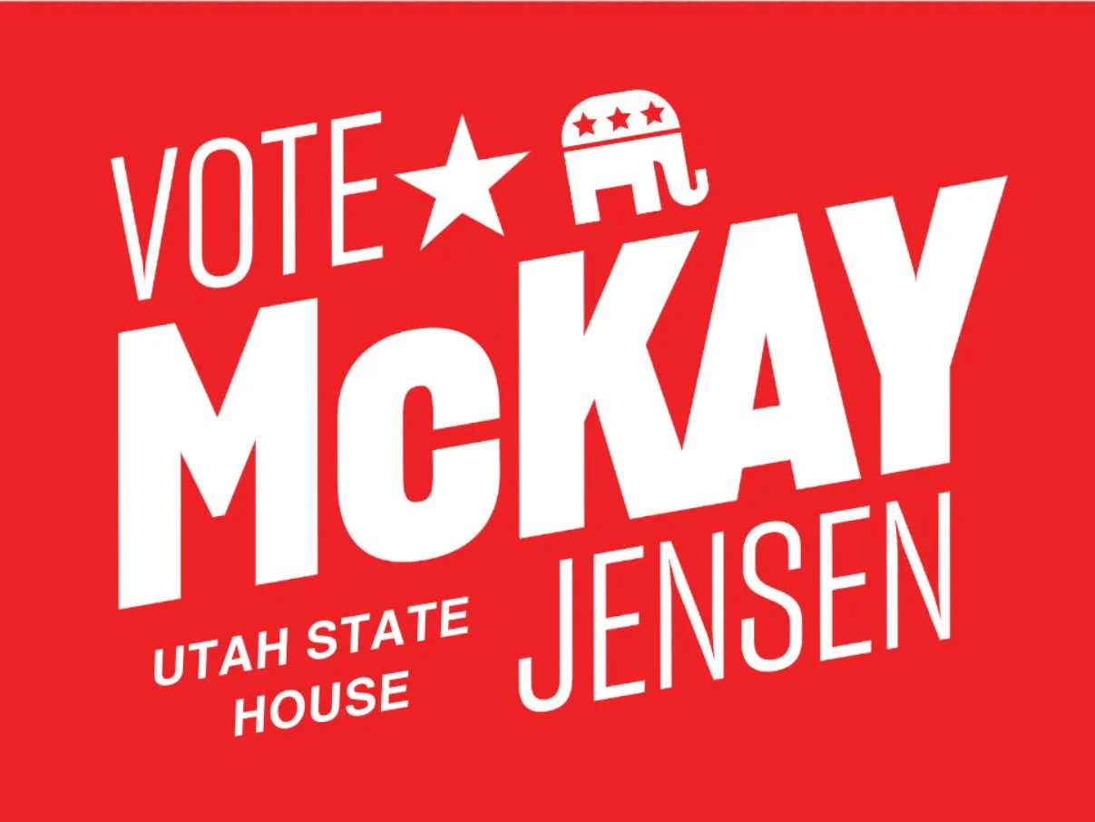 Red campaign sign supporting McKay and Jensen with white text and U.S. political symbols, including a star and an elephant, promoting voting for Utah State House.