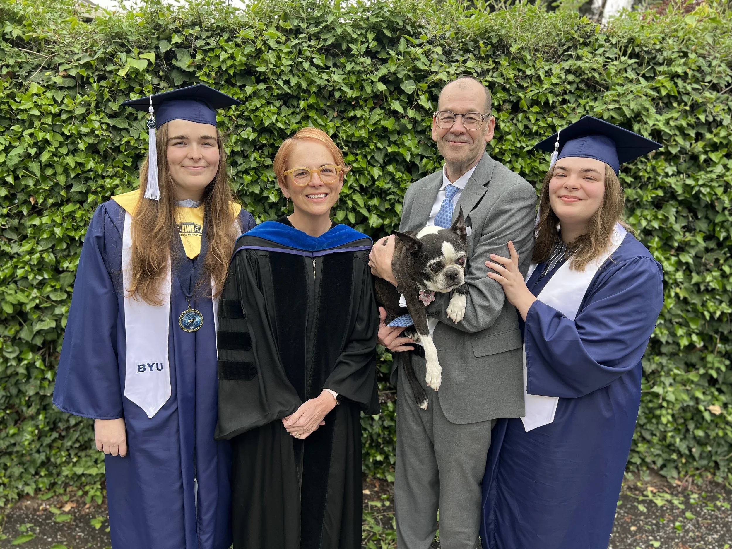 Jensen Family with McKay Jensen in BYU gowns and caps, and Amy in academic regalia.