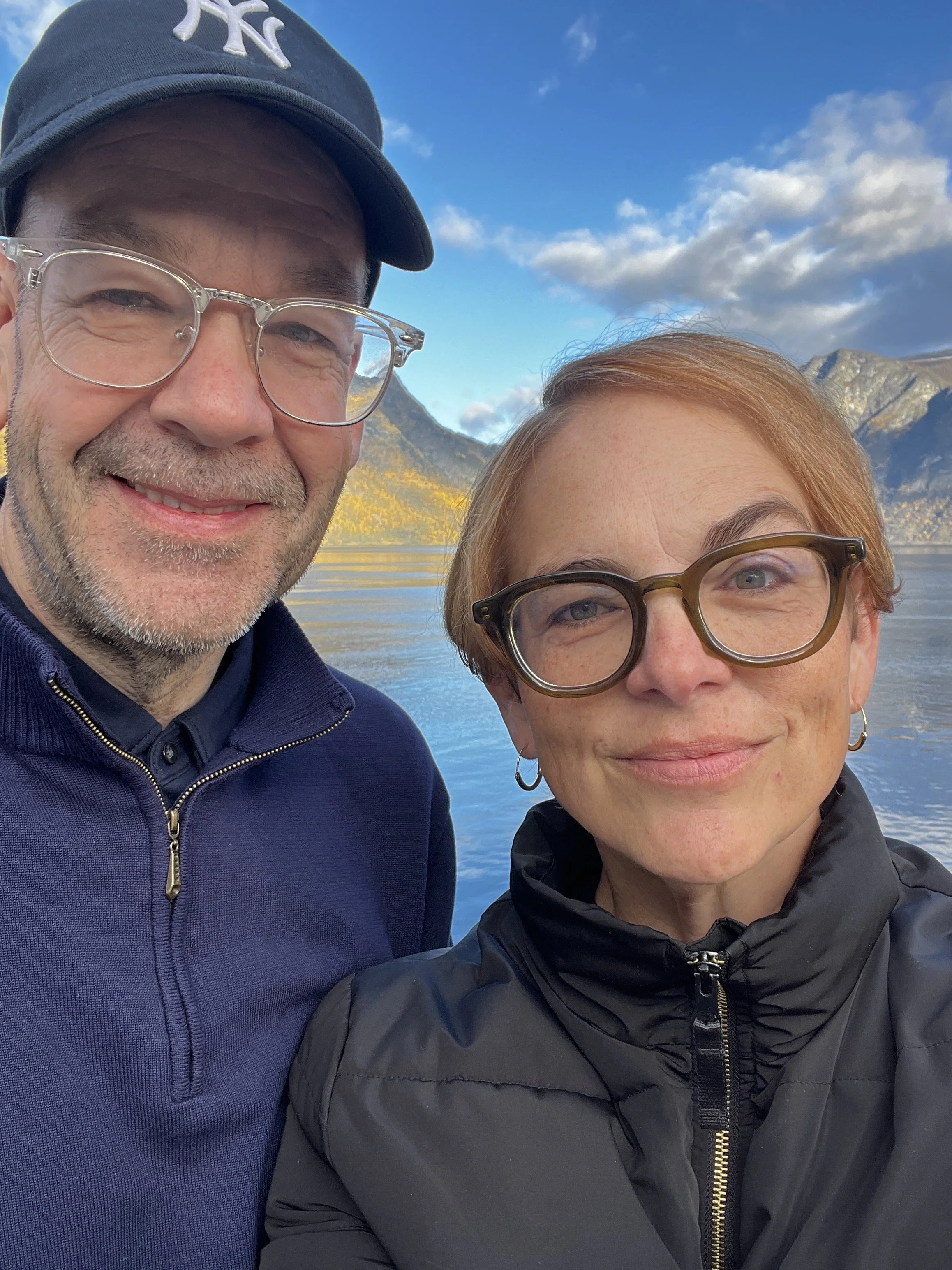 McKay and Amy taking a selfie outdoors in Norway under a partly cloudy sky.
