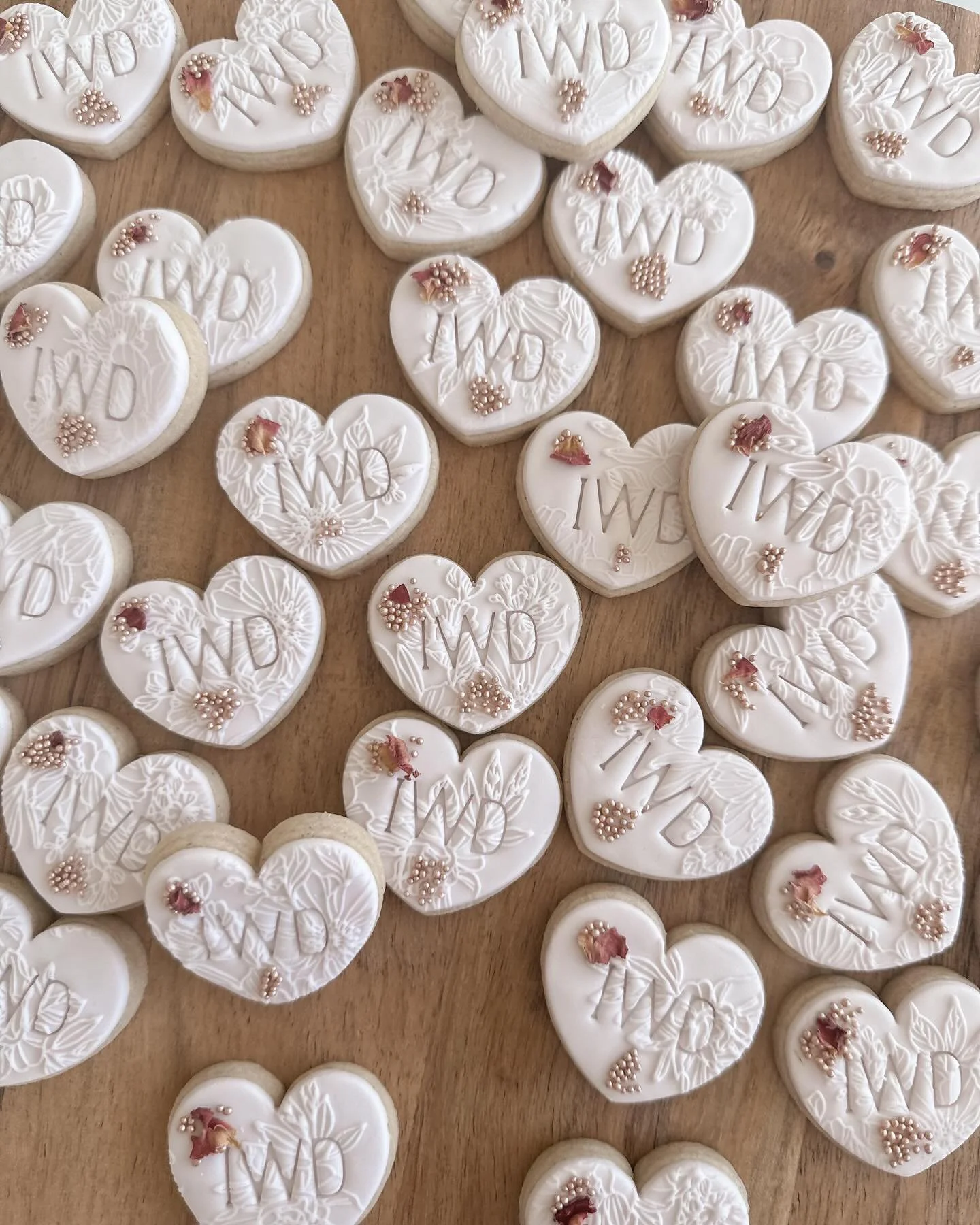 Corporate heart cookies with IWD stamped on them