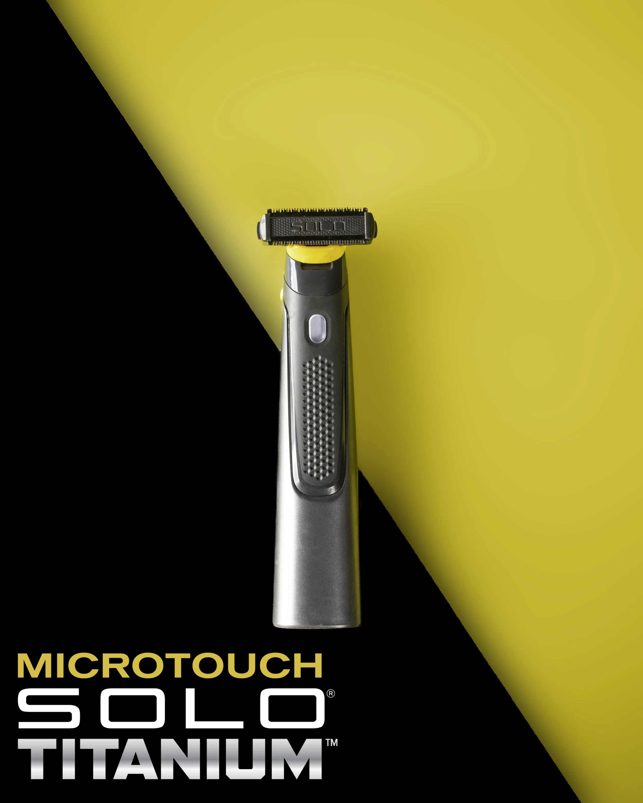A close-up of a titanium electric shaver with a yellow and black background and the text 'MicroTouch Solo Titanium' at the bottom.