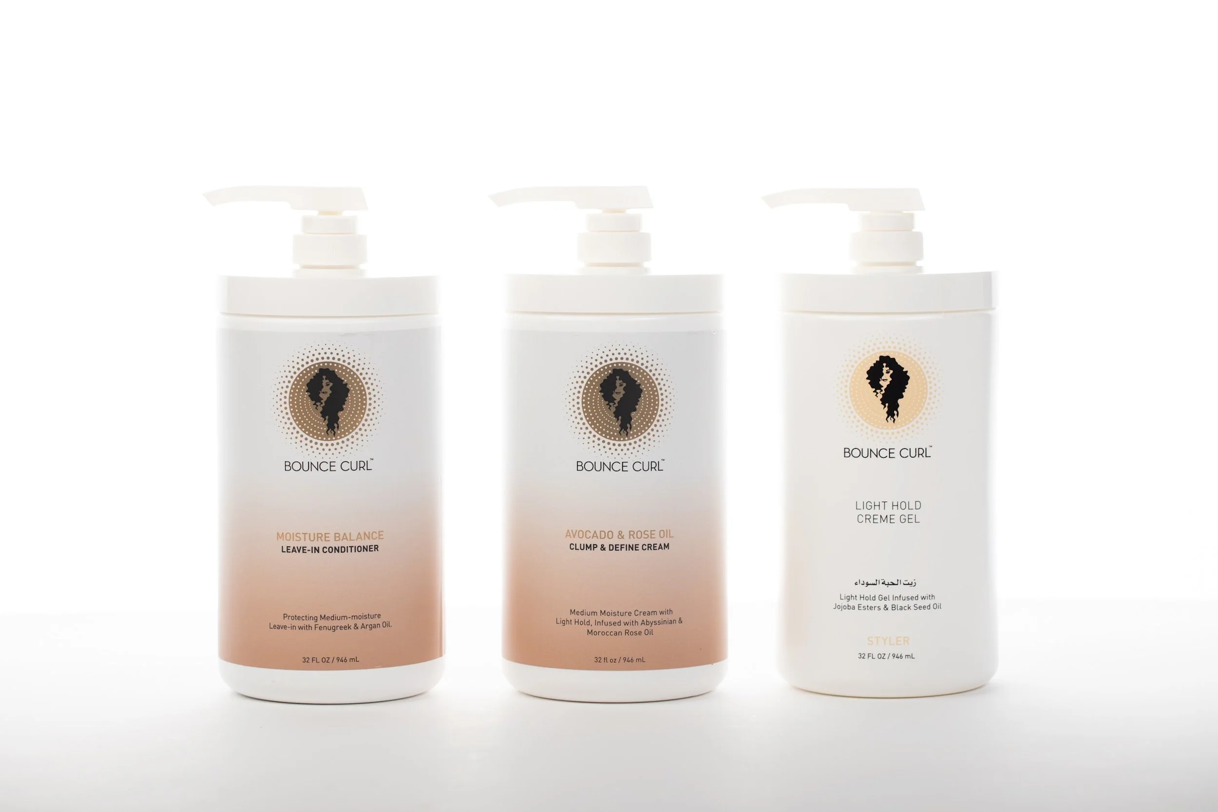 Three bottles of Bounce Curl hair products, each with pump dispensers, arranged side by side on a white background. The first is Moisture Balance Leave-In Conditioner, the second is Avocado & Rose Oil Clump & Define Cream, and the third is Light Hold