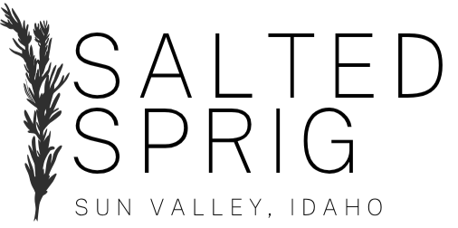 Illustration of a wheat stalk and a silhouette of a person's profile with wheat fields in the background.