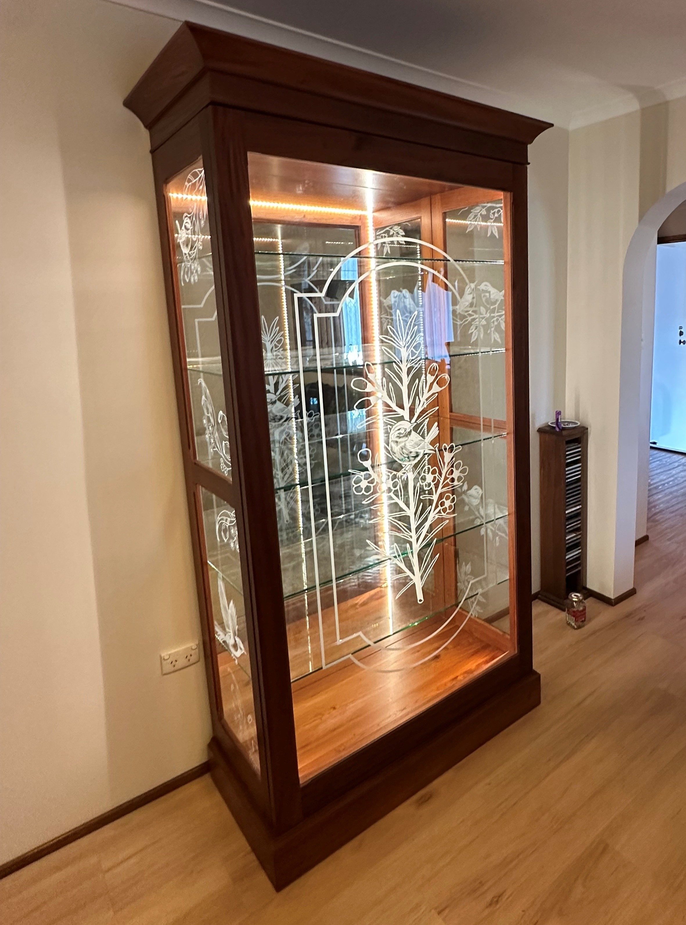 A beautifully crafted cedar display cabinet featuring a sliding door, glass shelving, mirror, lighting and custom etched glass panels. 
Handcrafted from start to finish!

#cedar #custom #displaycabinet #timber